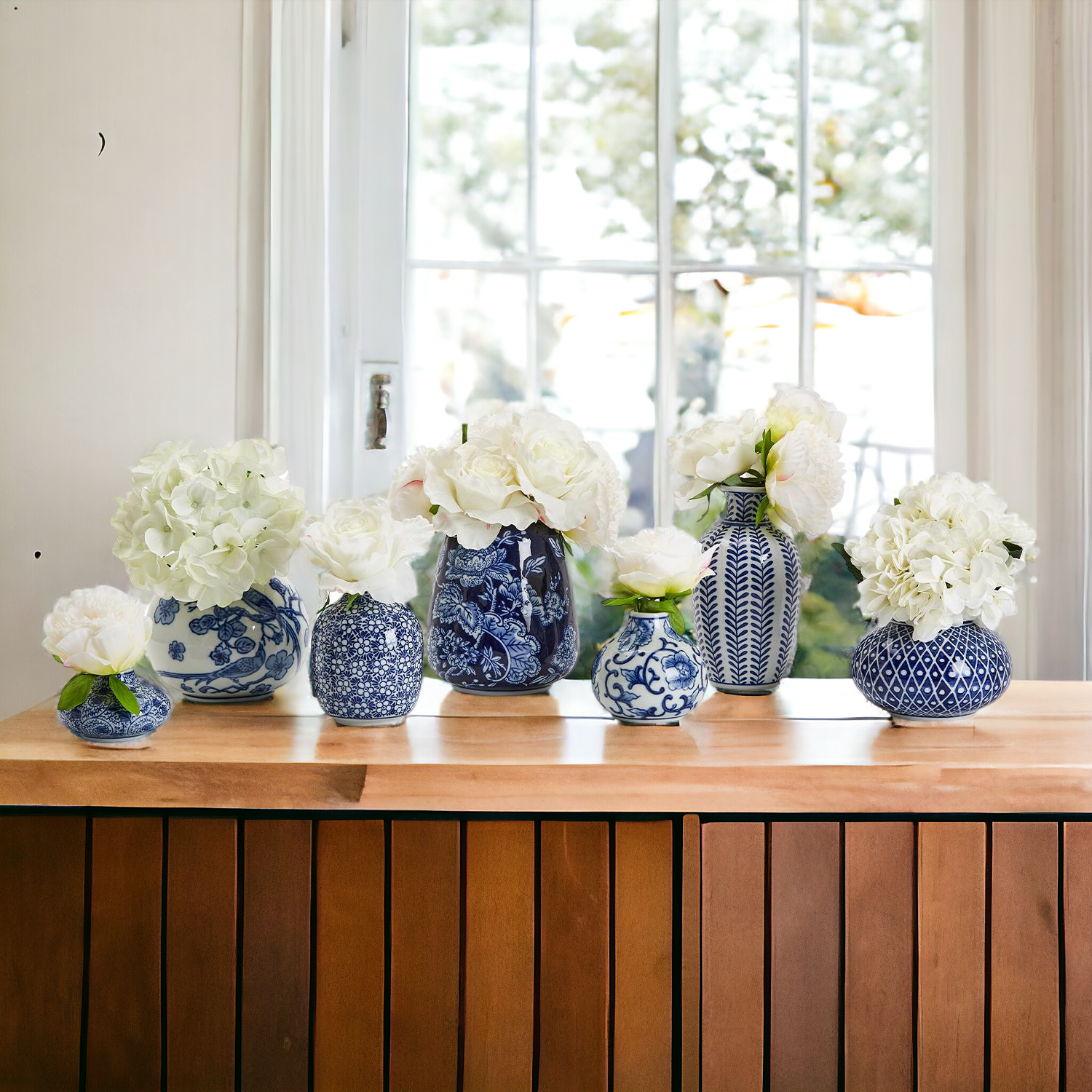 A collection of Samira Blue Vases featuring hand-painted porcelain in classic blue and white designs, showcasing various sizes and styles.