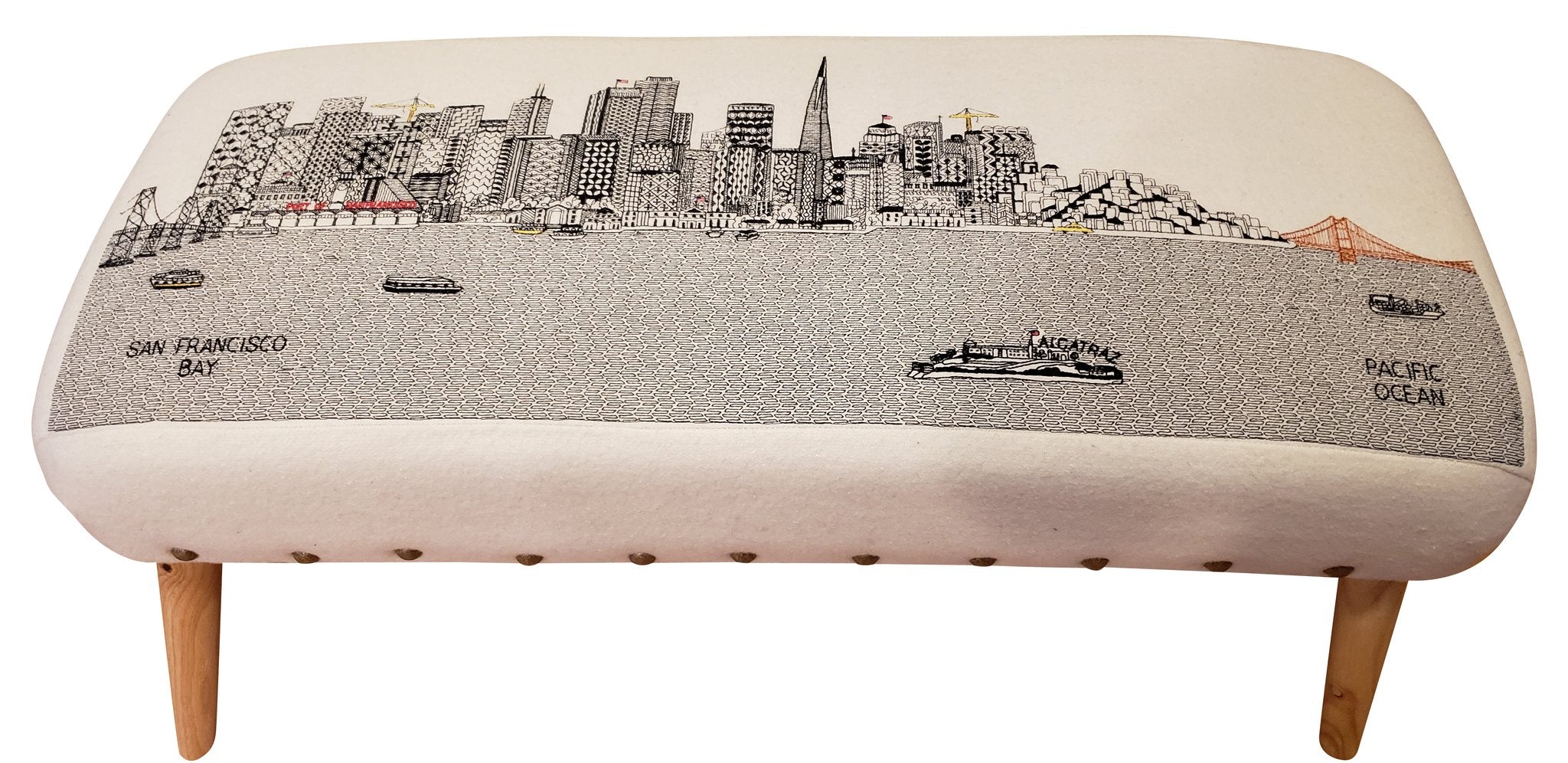 Handcrafted San Francisco Ottoman featuring embroidered city landmarks on wool upholstery.