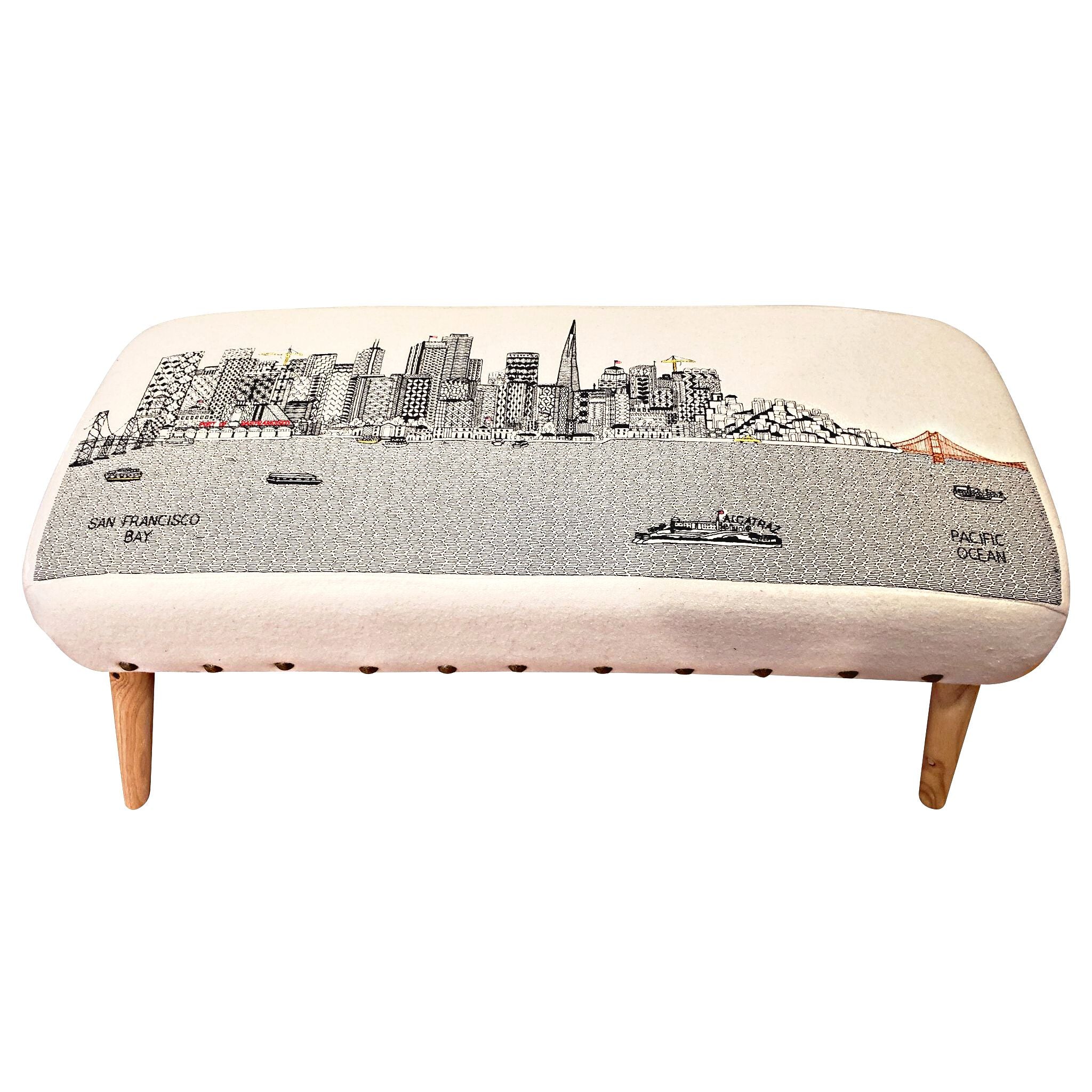 Handcrafted San Francisco Ottoman featuring embroidered city landmarks on wool upholstery.