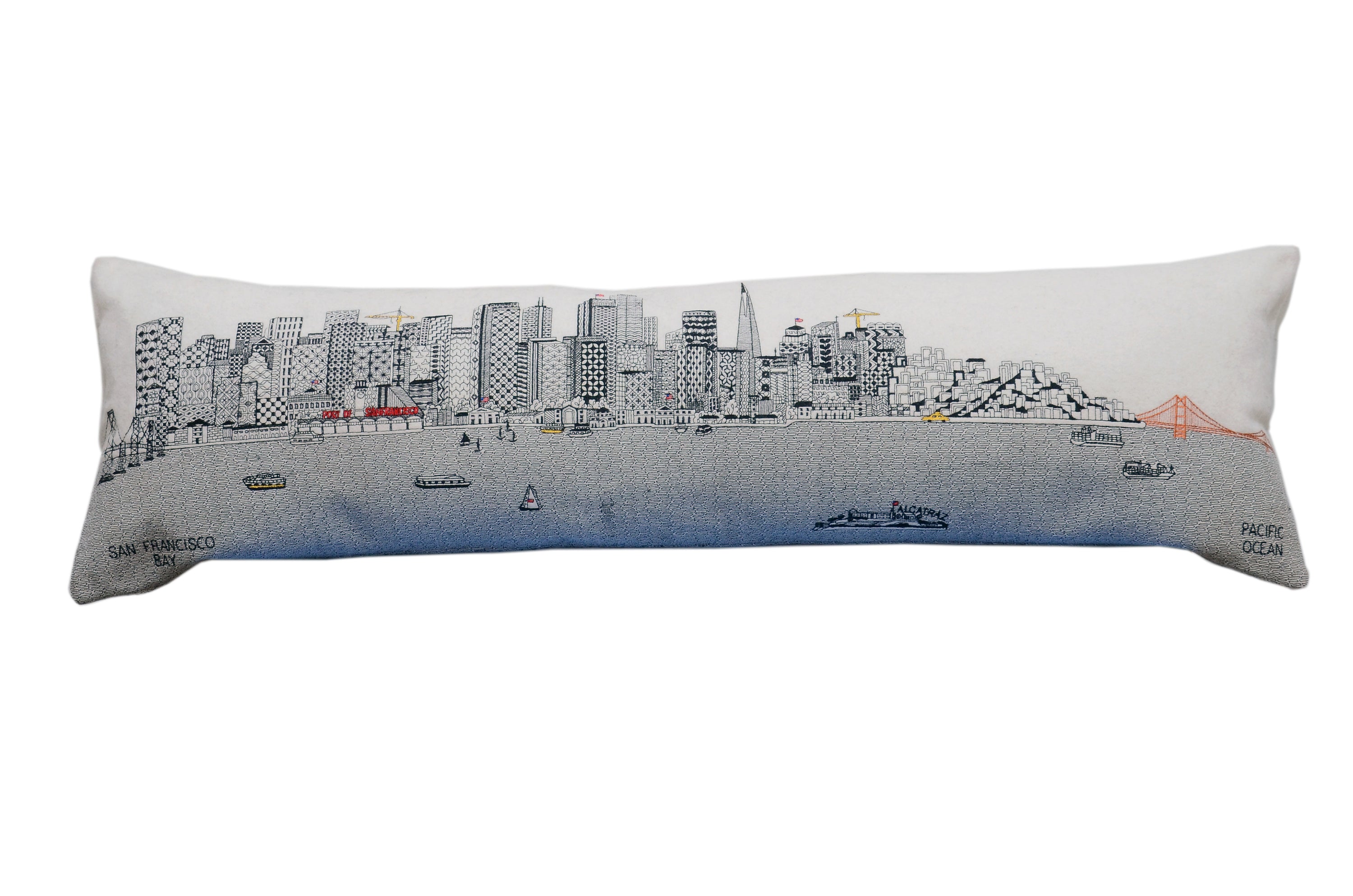 San Francisco Pillow featuring embroidered landmarks like the Golden Gate Bridge and Alcatraz Island, with a red zipper at the bottom.