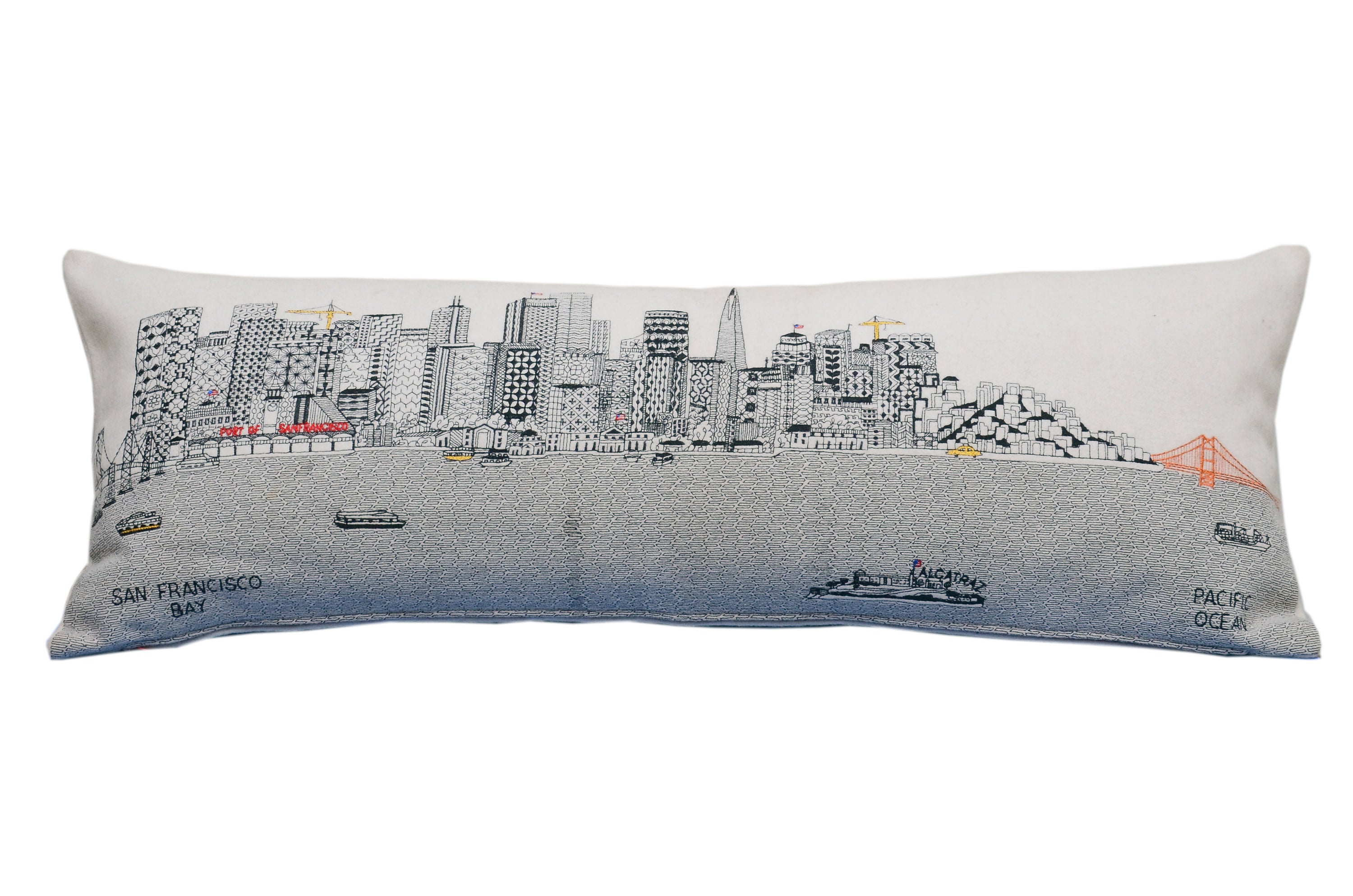 San Francisco Pillow featuring embroidered landmarks like the Golden Gate Bridge and Alcatraz Island, with a red zipper at the bottom.