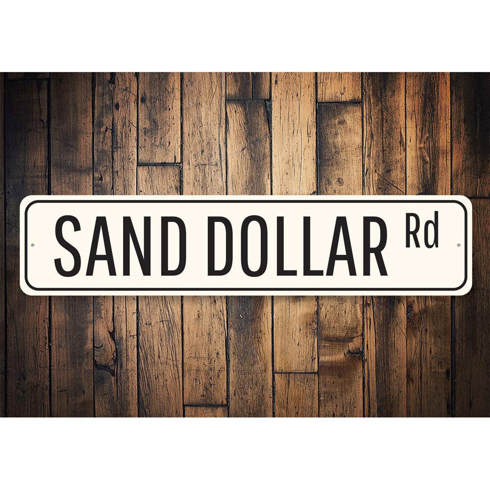 A decorative Sand Dollar Road Sign made of high-quality aluminum, featuring a coastal design perfect for home decor.