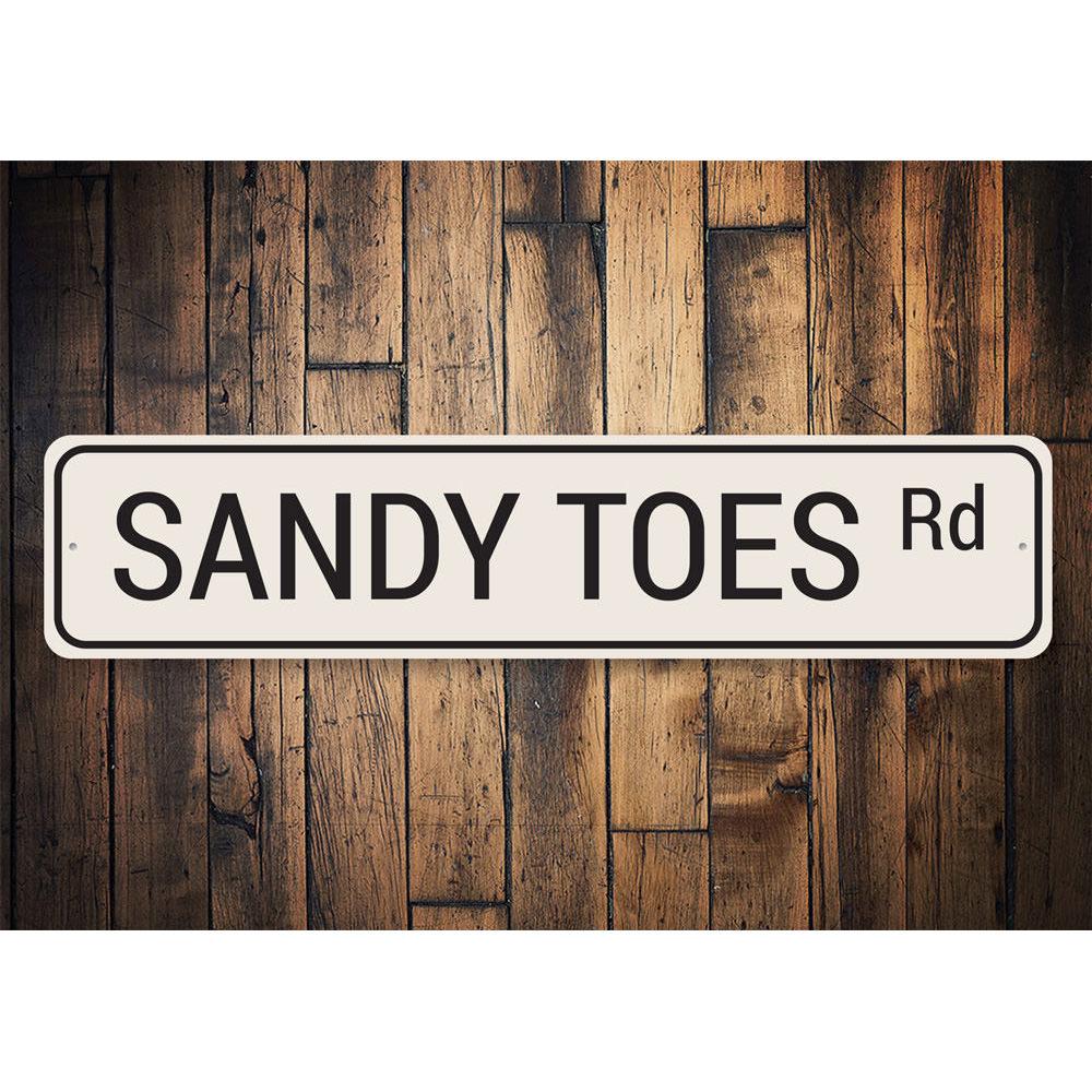 Sandy Toes Road Sign made of high-quality aluminum, featuring vibrant colors and a beach-themed design, perfect for coastal decor.