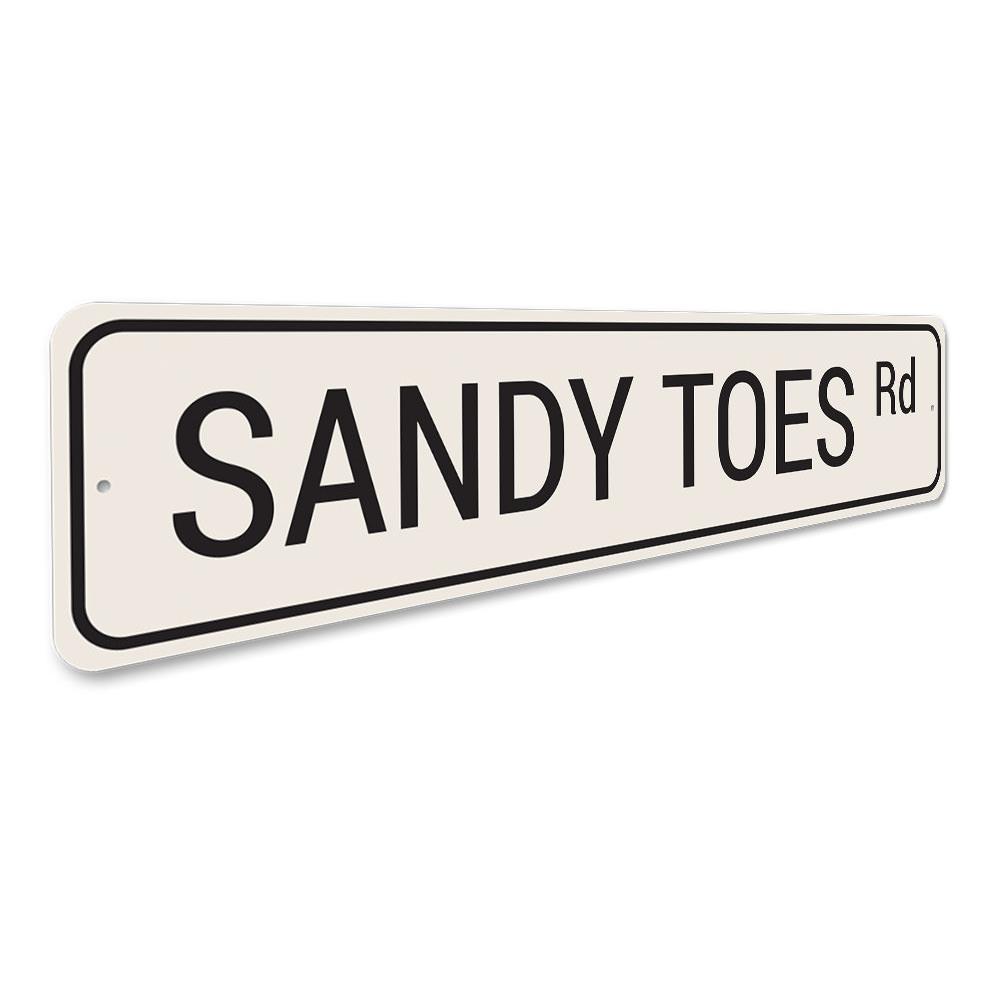 Sandy Toes Road Sign made of high-quality aluminum, featuring vibrant colors and a beach-themed design, perfect for coastal decor.