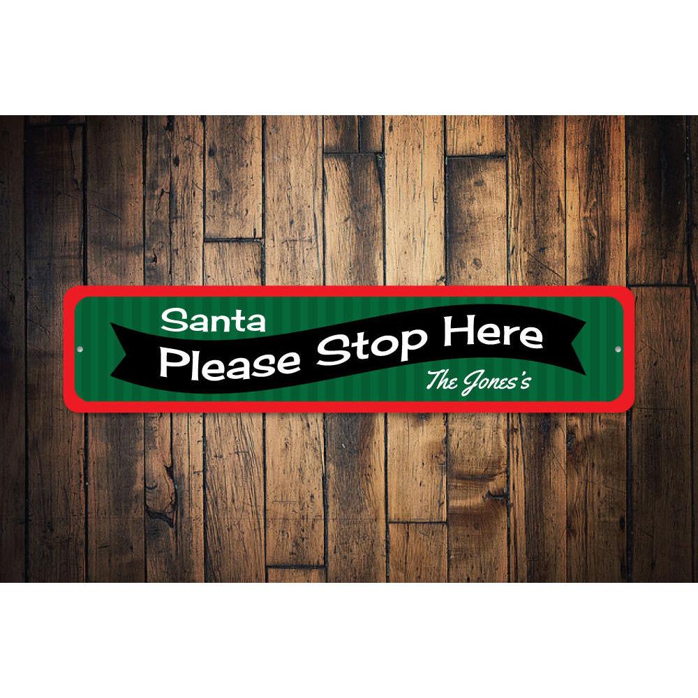 A festive Santa Please Stop Here banner sign made of high-quality aluminum, featuring vibrant colors and a charming design, perfect for holiday decorations.