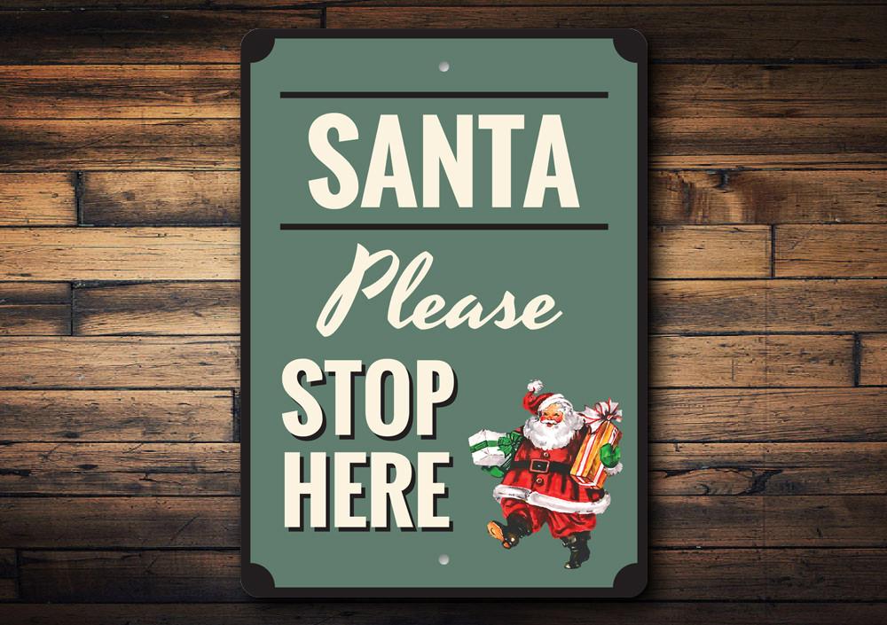 A festive Santa Please Stop Here Sign made of high-quality aluminum, featuring vibrant colors and a charming design perfect for holiday decorations.