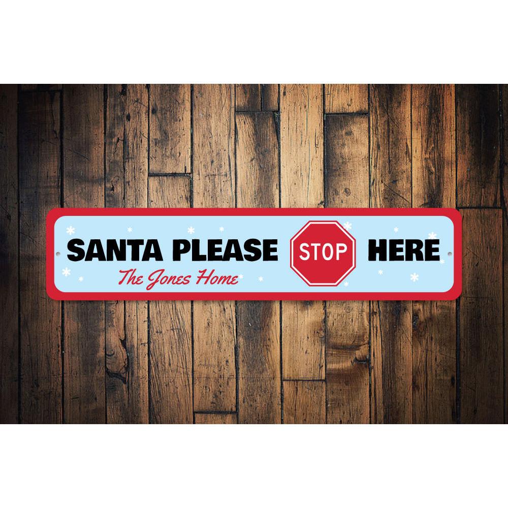 A festive Santa Please Stop Here Sign made of high-quality aluminum, featuring a charming design perfect for Christmas decorations.