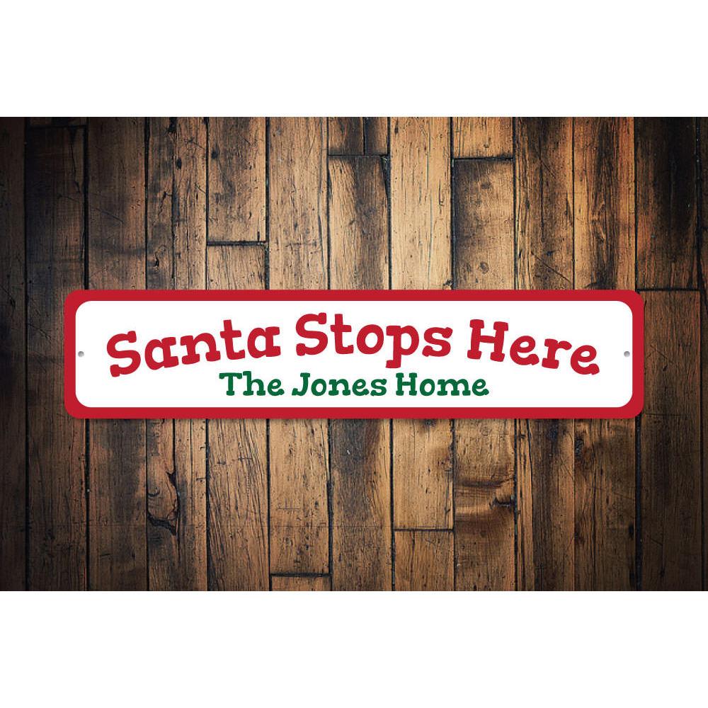 A festive Santa Stop Here Sign made of high-quality aluminum, featuring vibrant colors and a charming design perfect for Christmas decorations.