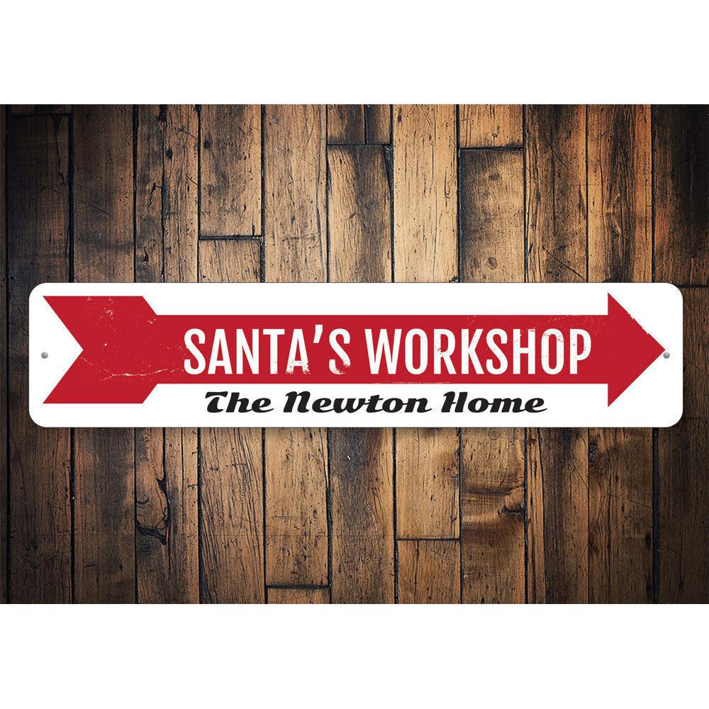 A festive Santa's Workshop Sign made of high-quality aluminum, featuring a charming design perfect for holiday decorations.