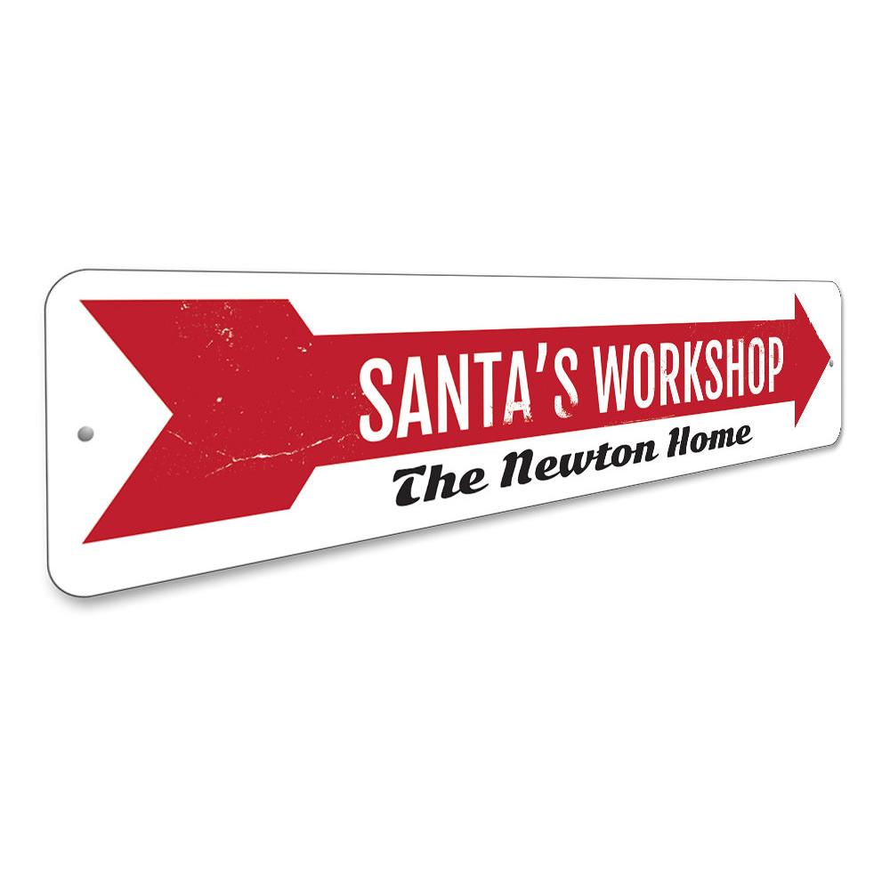 A festive Santa's Workshop Sign made of high-quality aluminum, featuring a charming design perfect for holiday decorations.