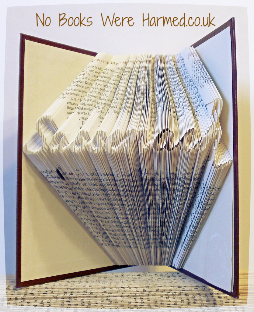 Handcrafted Sassenach book art made from vintage books, showcasing intricate page folds and unique design.