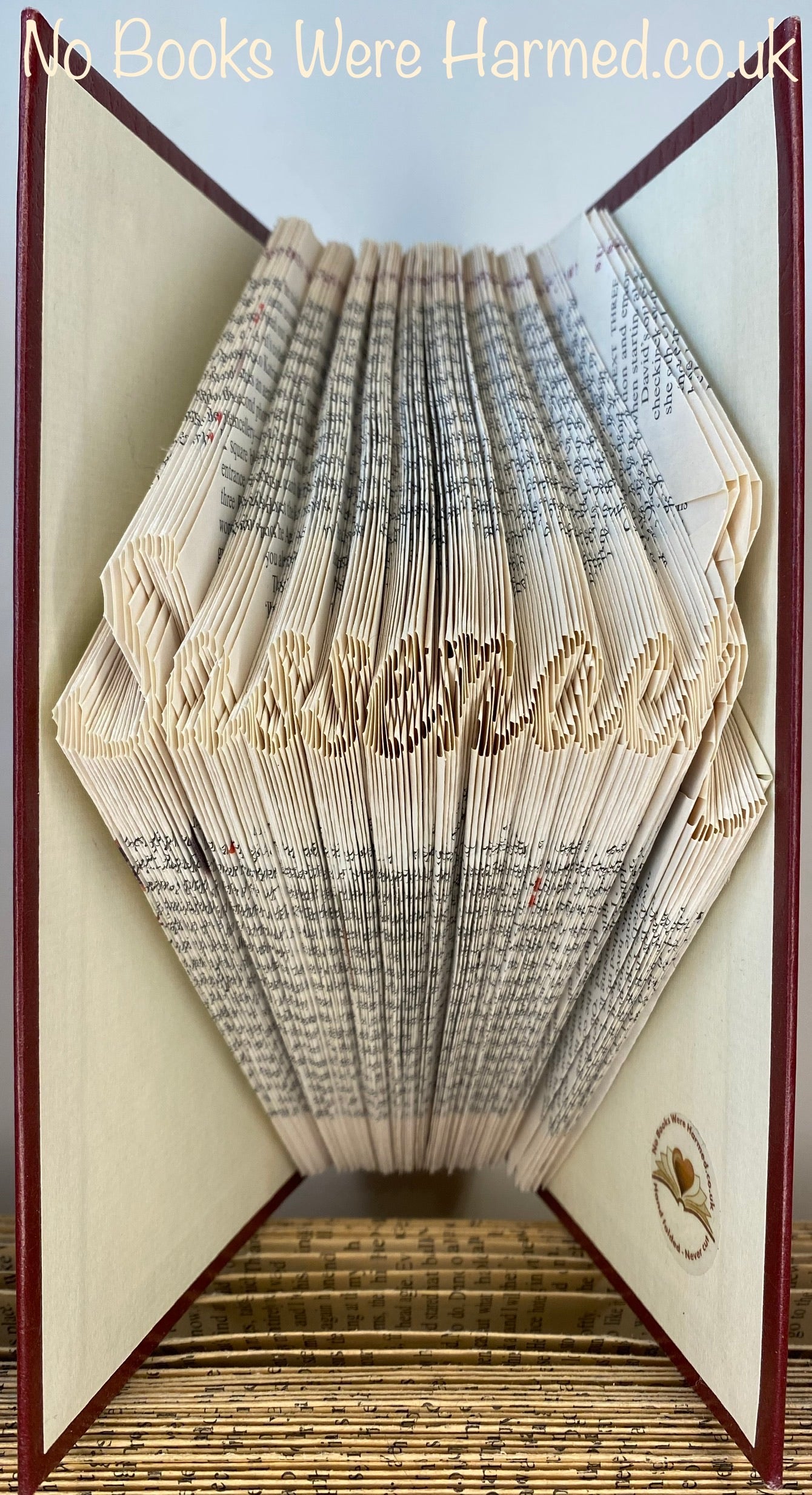 Handcrafted Sassenach book art made from vintage books, showcasing intricate page folds and unique design.