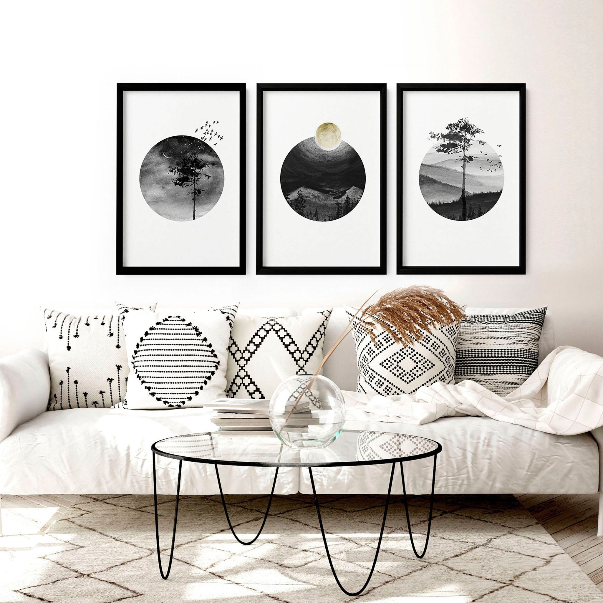 Set of 3 framed Scandi wall art prints featuring greyscale Nordic landscapes in minimal circular designs, perfect for home decor.