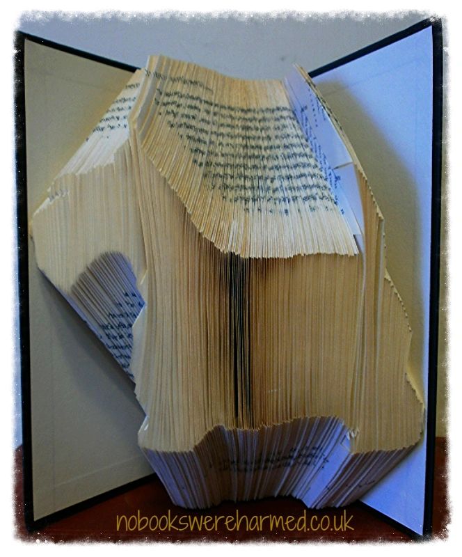 Handcrafted Scotty Dog silhouette art made from vintage books, showcasing unique folds and textures.