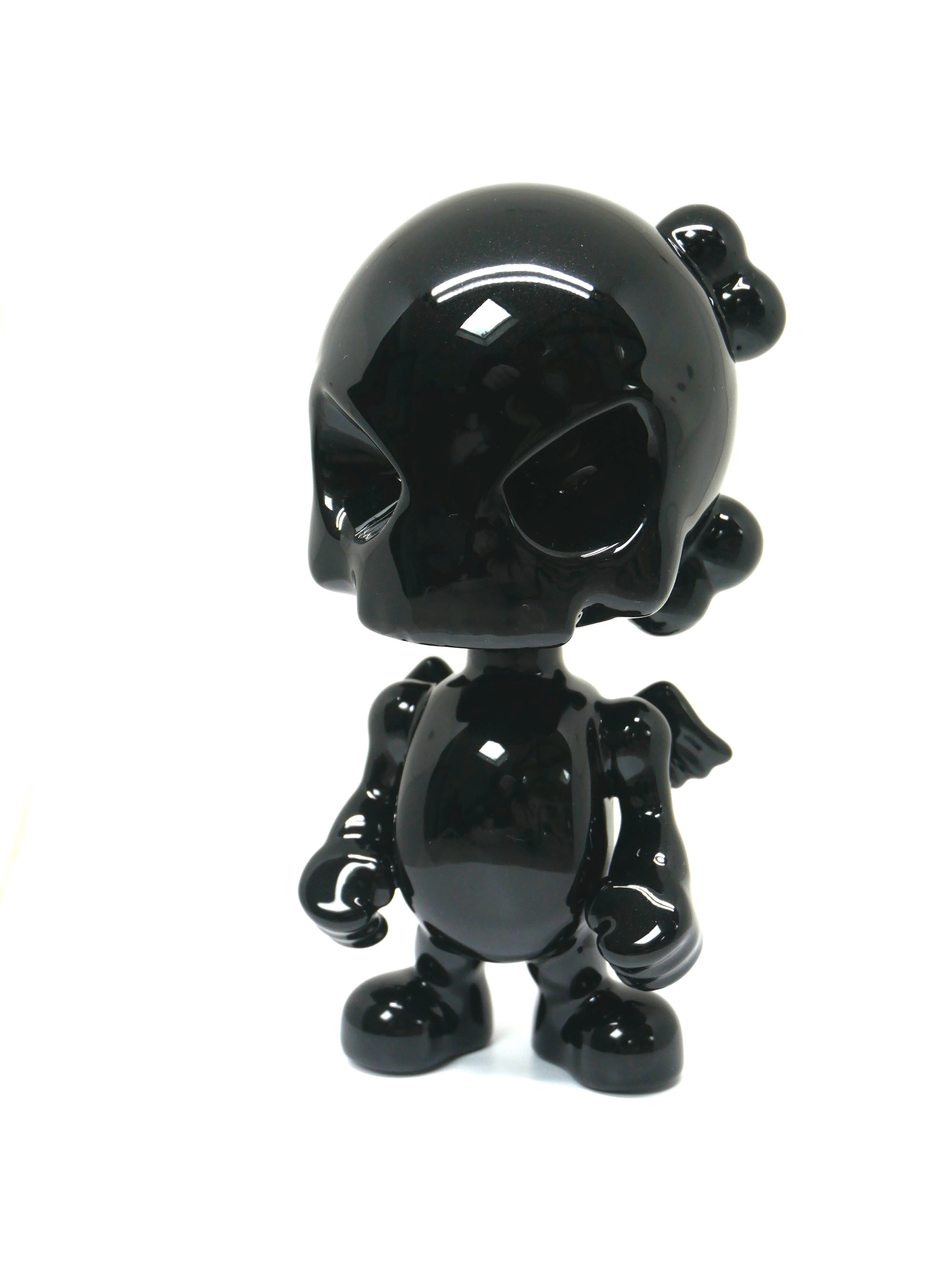 SkullHead Black Porcelain sculpture by Huck Gee, showcasing intricate details and a sleek black finish.