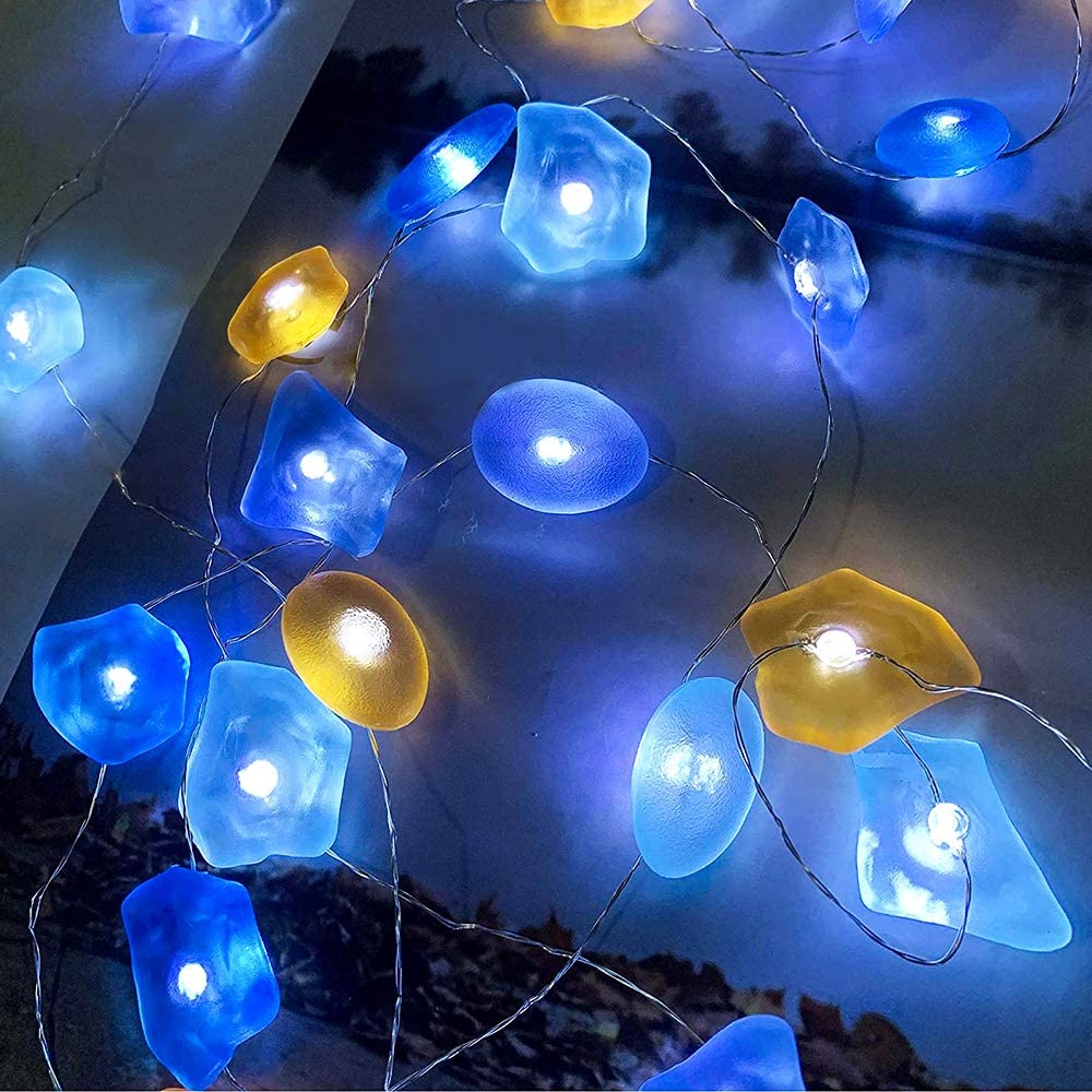 A beautiful display of Sea Glass String Lights with 30 vibrant LEDs on silver wire, showcasing their elegant design and waterproof features.