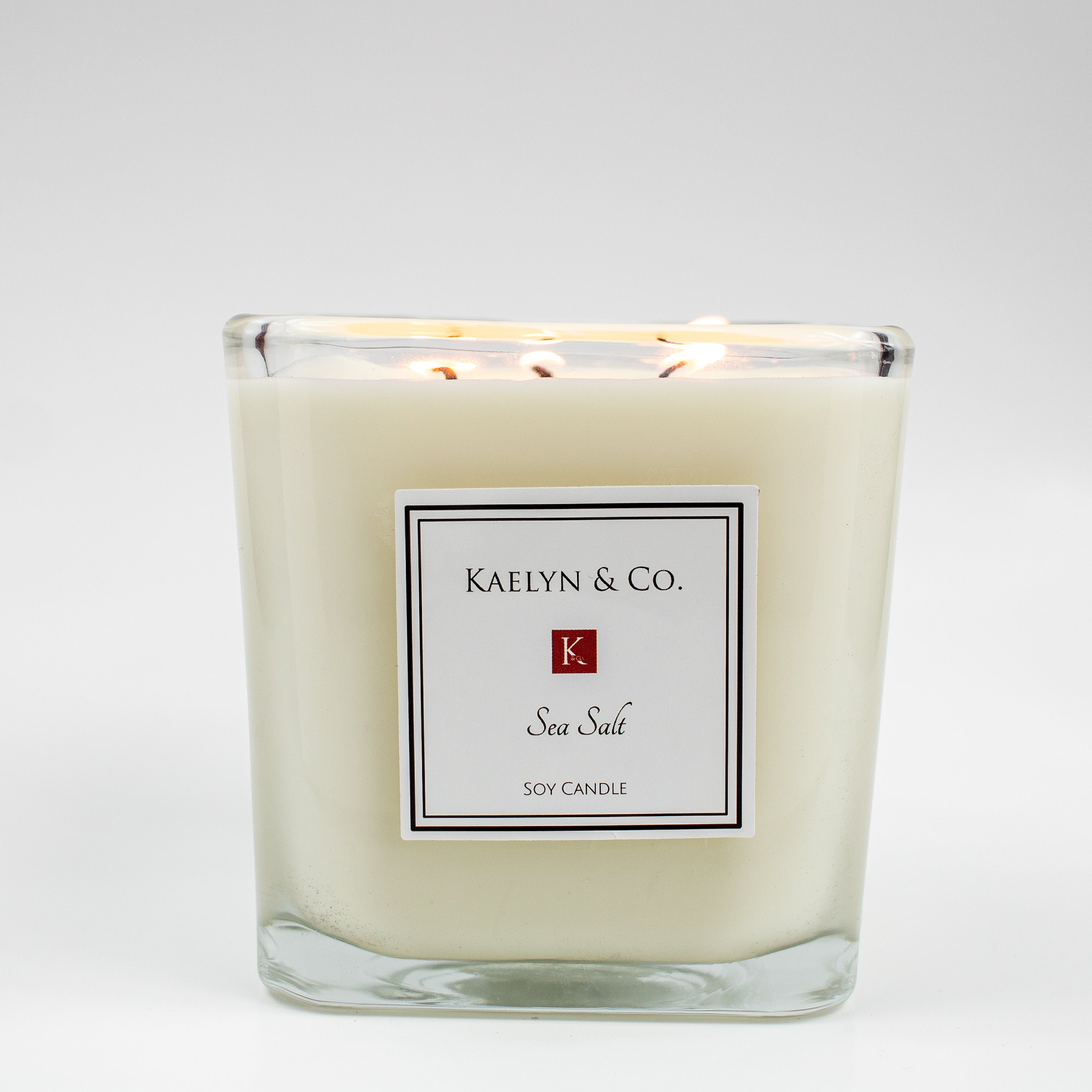 A large cube candle in sea salt scent, featuring a floral and musk aroma, with a hint of orange essential oil, elegantly displayed.