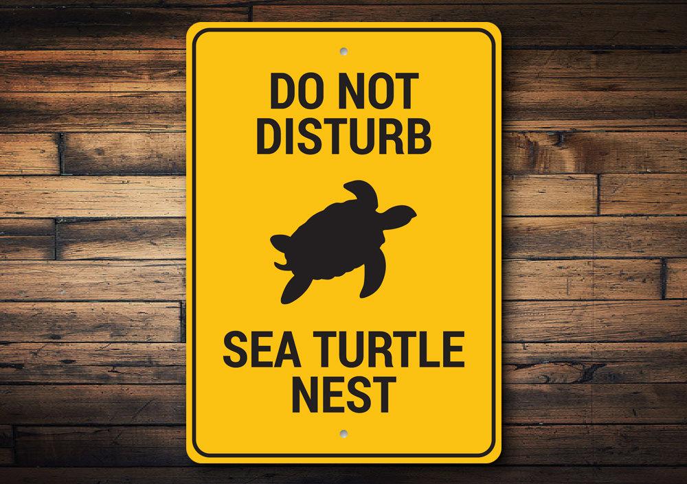 A beautifully crafted Sea Turtle Nest Sign made of high-quality aluminum, featuring a vibrant design perfect for beach-themed decor.