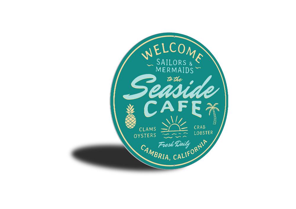 A beautifully crafted Seaside Cafe Sign made of high-quality aluminum, featuring vibrant colors and a charming coastal design, perfect for home decor.