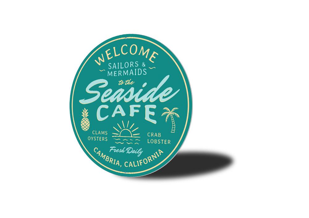 A beautifully crafted Seaside Cafe Sign made of high-quality aluminum, featuring vibrant colors and a charming coastal design, perfect for home decor.