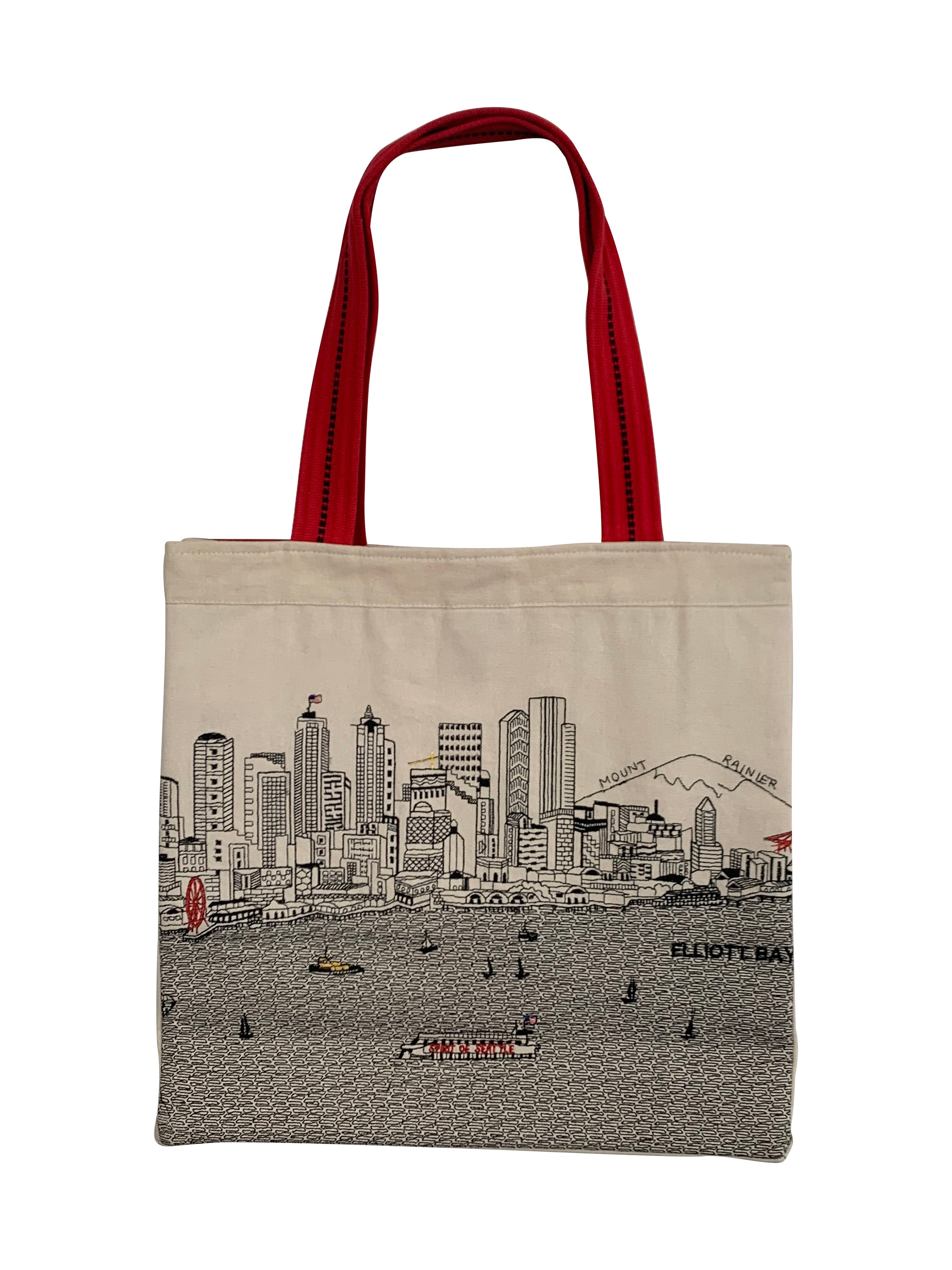 Seattle Tote Bag featuring an embroidered skyline design on cream and black cotton canvas with red waterproof lining and straps.