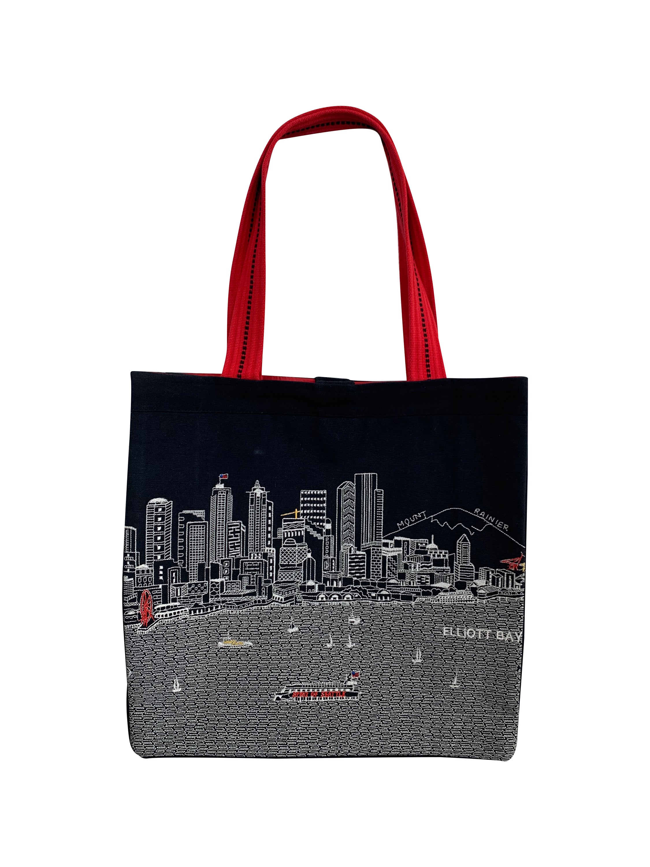 Seattle Tote Bag featuring an embroidered skyline design on cream and black cotton canvas with red waterproof lining and straps.