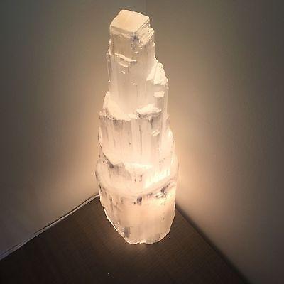 A beautifully handcrafted Selenite Crystal Skyscraper Lamp, showcasing its unique shape and natural glow.