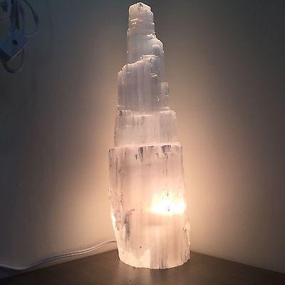 A beautifully handcrafted Selenite Crystal Skyscraper Lamp, showcasing its unique shape and natural glow.