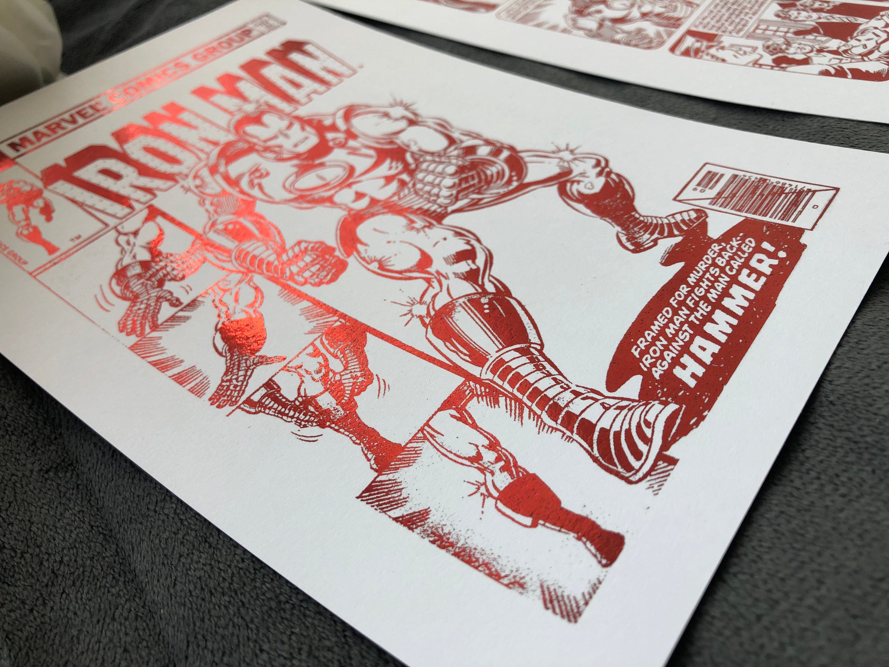 Set of 2 Iron Man foil prints featuring dynamic comic cover and comic strip designs with metallic finish.