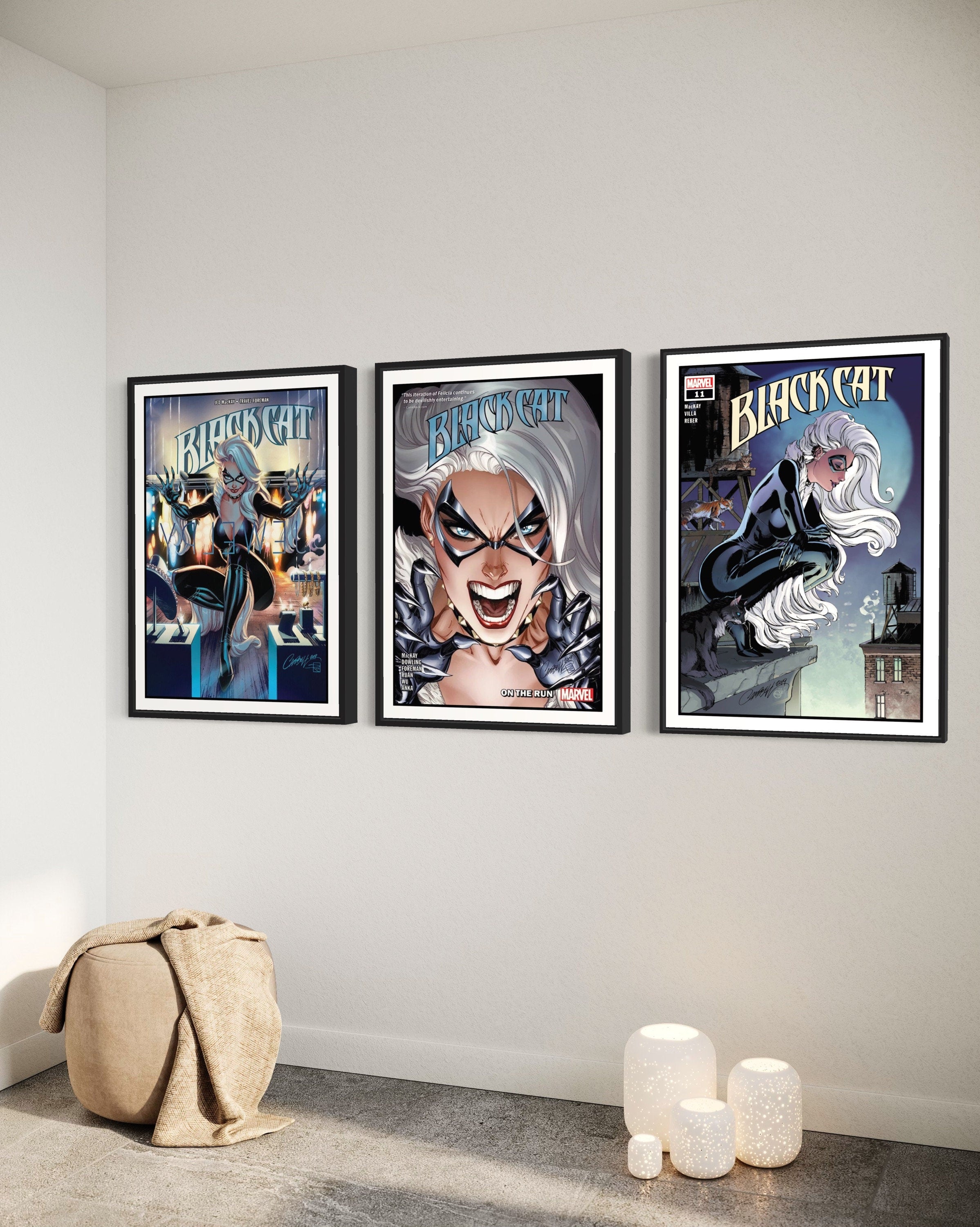 Set of 3 Black Cat comic cover prints showcasing vibrant artwork and dynamic poses of the character.