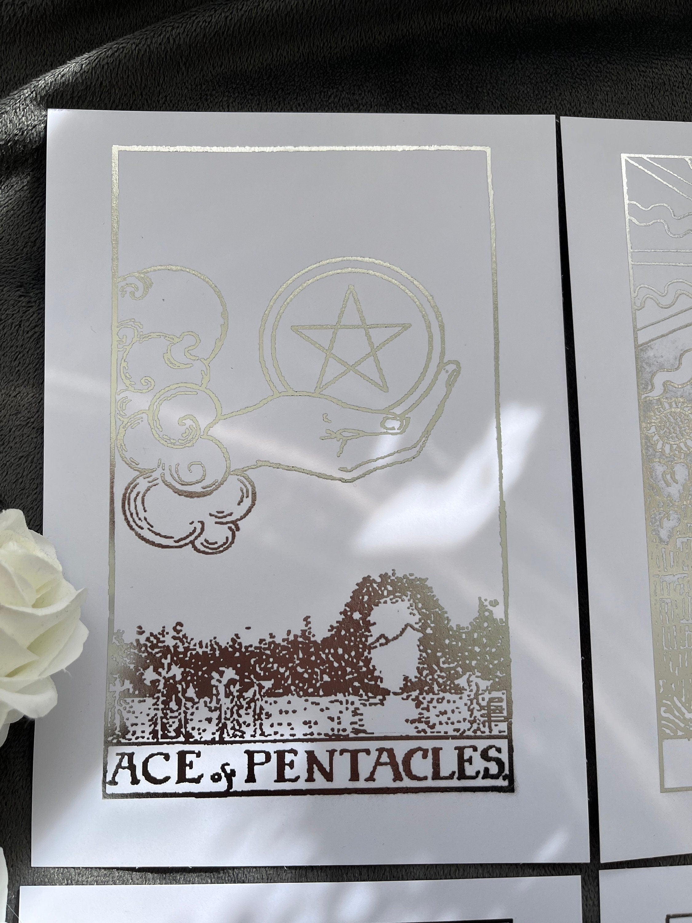 Set of 4 tarot card foil prints featuring Ace of Cups, The Sun, The Star, and Ace of Pentacles in shimmering silver accents.