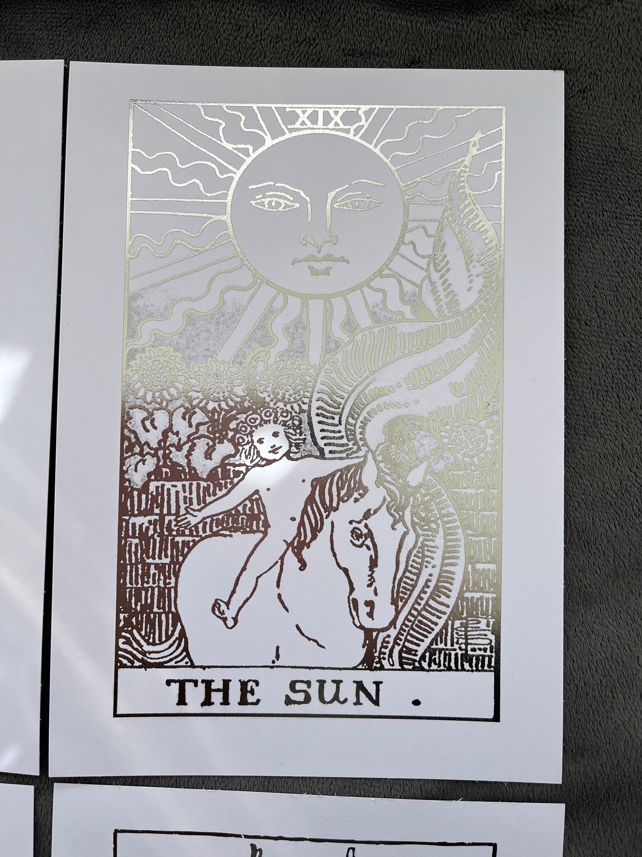 Set of 4 tarot card foil prints featuring Ace of Cups, The Sun, The Star, and Ace of Pentacles in shimmering silver accents.