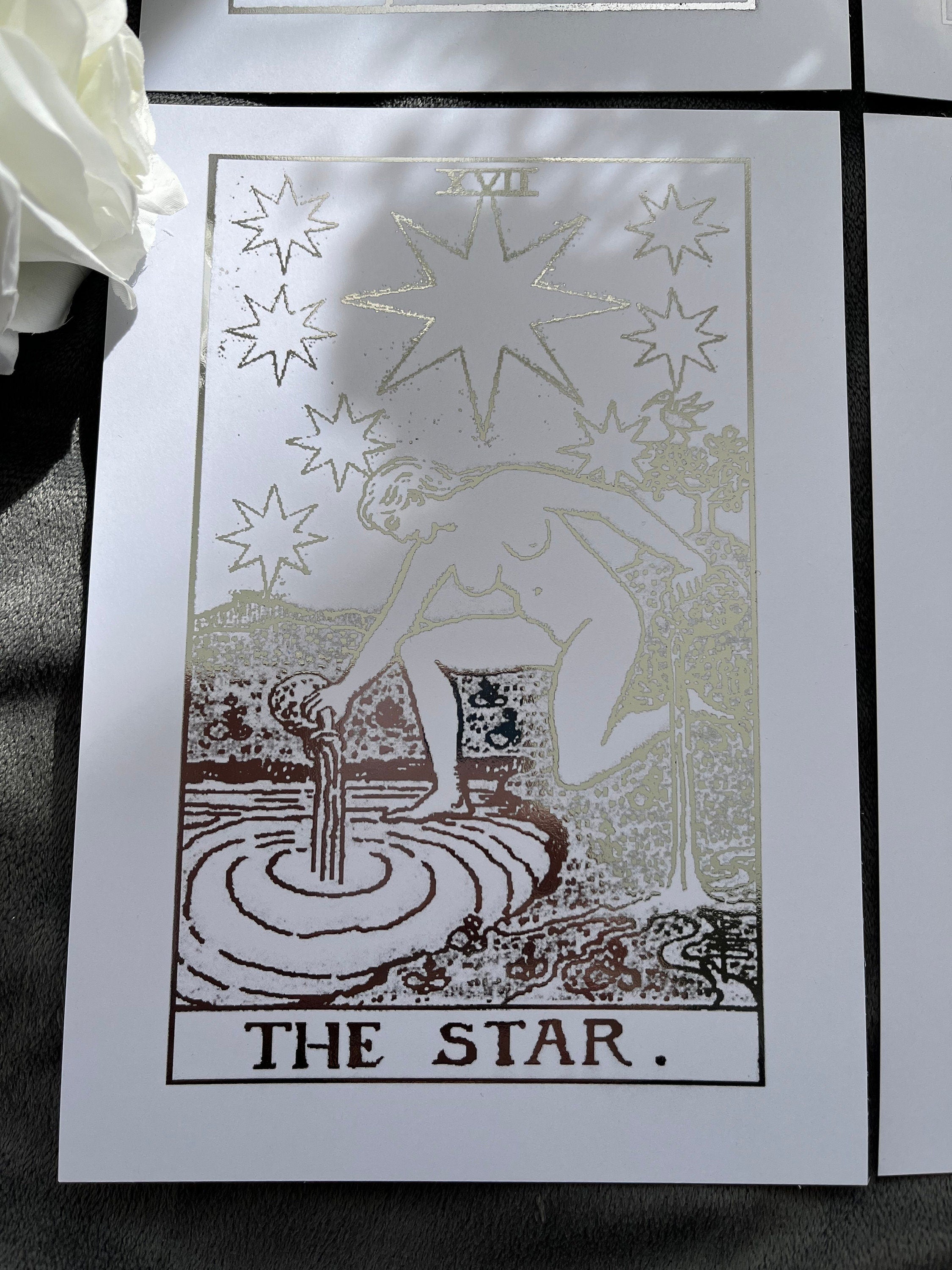 Set of 4 tarot card foil prints featuring Ace of Cups, The Sun, The Star, and Ace of Pentacles in shimmering silver accents.