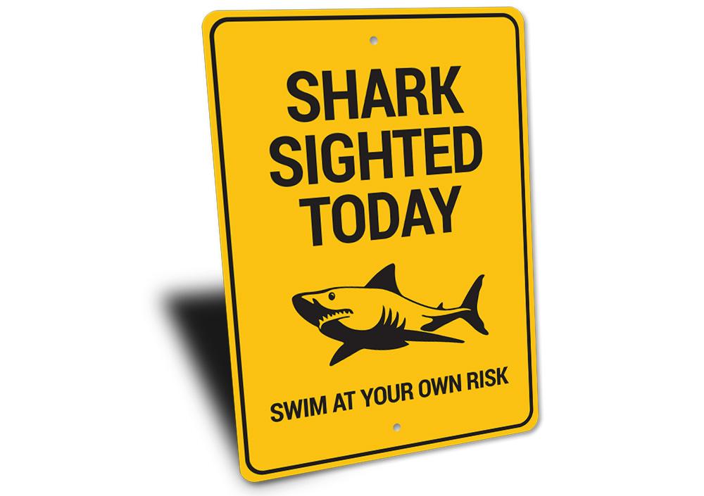 A decorative Shark Sighted Sign made of high-quality aluminum, featuring a vibrant design perfect for beach-themed decor.