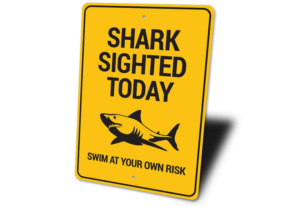 A decorative Shark Sighted Sign made of high-quality aluminum, featuring a vibrant design perfect for beach-themed decor.