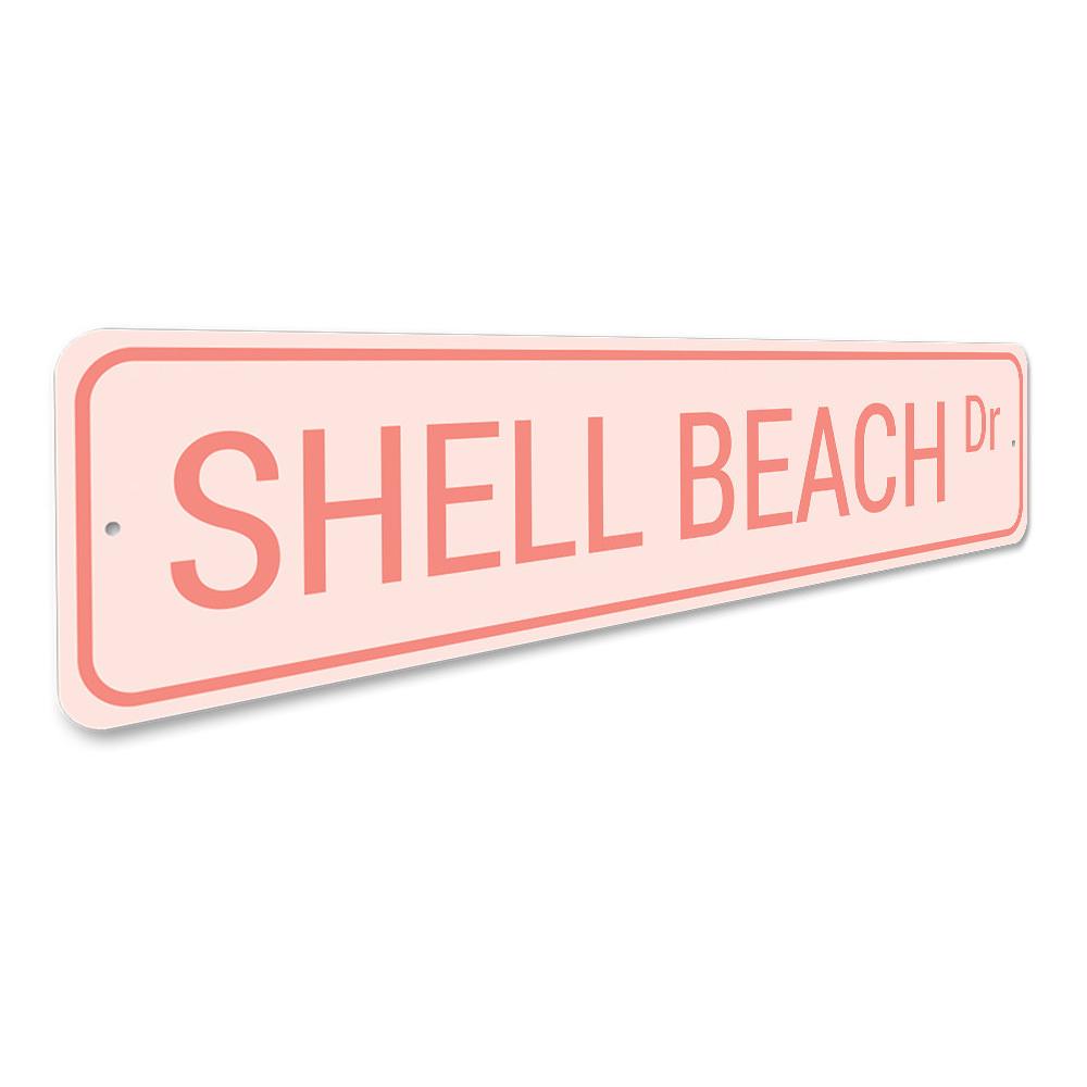 A decorative Shell Beach Drive Sign made of high-quality aluminum, featuring a coastal design perfect for beach houses and outdoor decor.