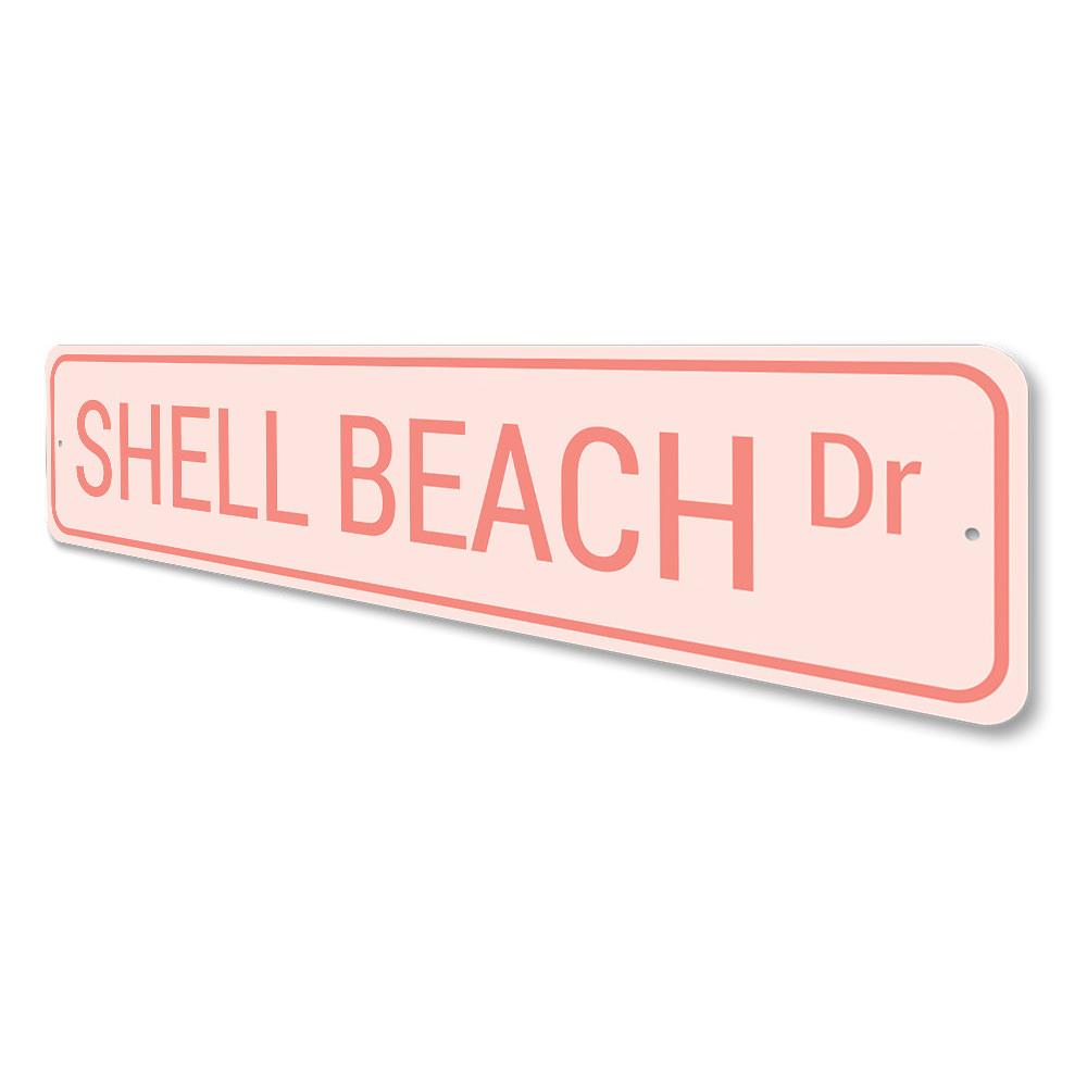 A decorative Shell Beach Drive Sign made of high-quality aluminum, featuring a coastal design perfect for beach houses and outdoor decor.