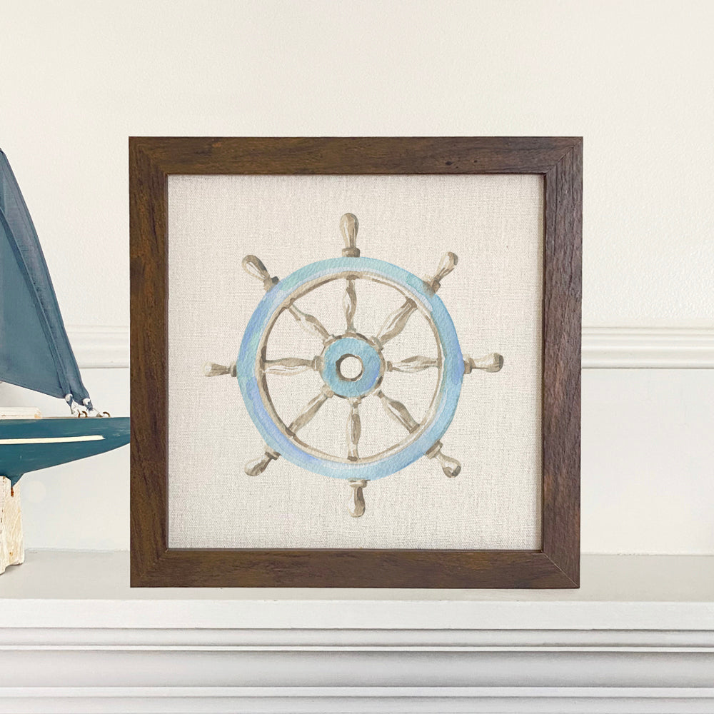 A beautifully framed ship wheel sign with a natural wood frame and eco-friendly ink printing on a linen-look background.