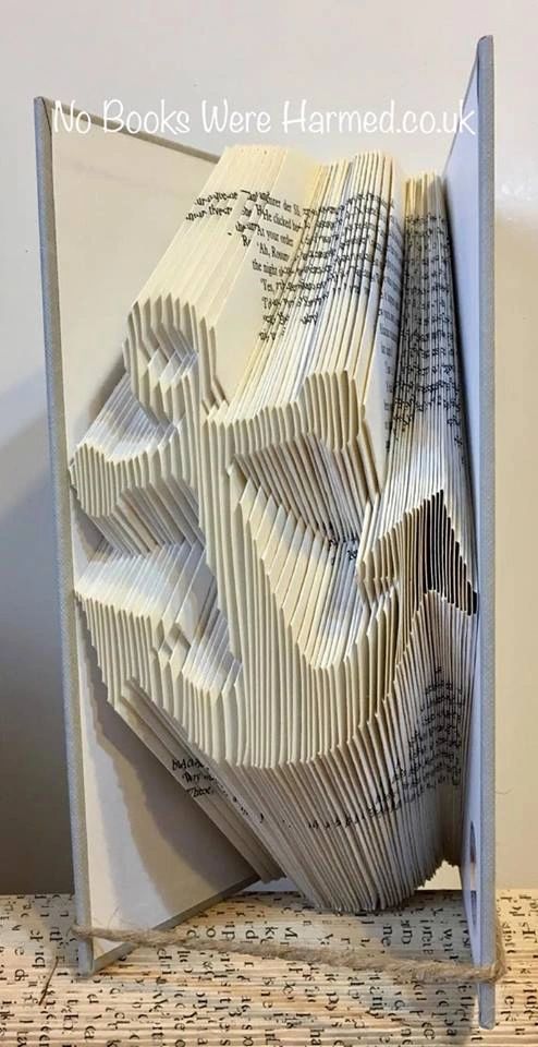 Handcrafted Ship's Anchor art made from vintage book pages, showcasing intricate folds and unique design.