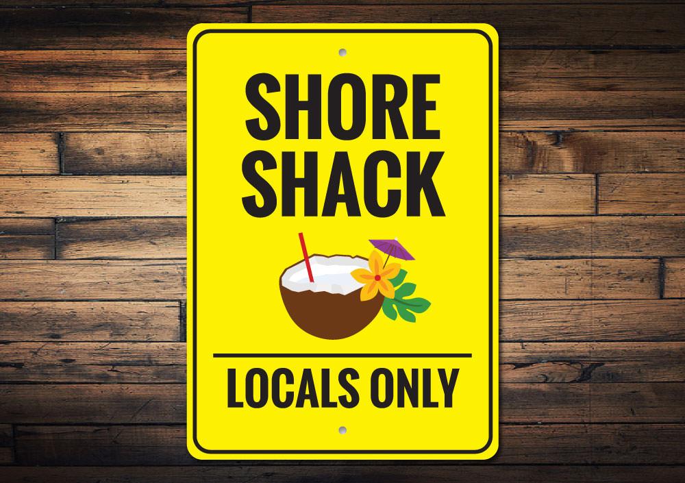 A vibrant Shore Shack Sign made of durable aluminum, featuring beach-themed graphics, perfect for coastal decor.