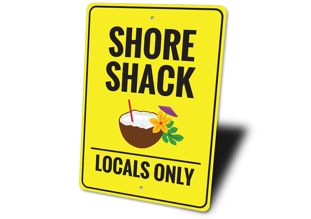 A vibrant Shore Shack Sign made of durable aluminum, featuring beach-themed graphics, perfect for coastal decor.