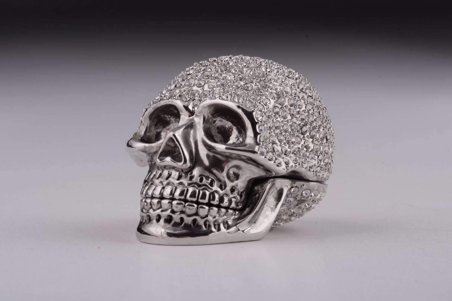 A beautifully crafted Silver Decorated Skull trinket box featuring intricate enamel painting and handpicked Austrian crystals, plated with 24K gold or 925 silver.