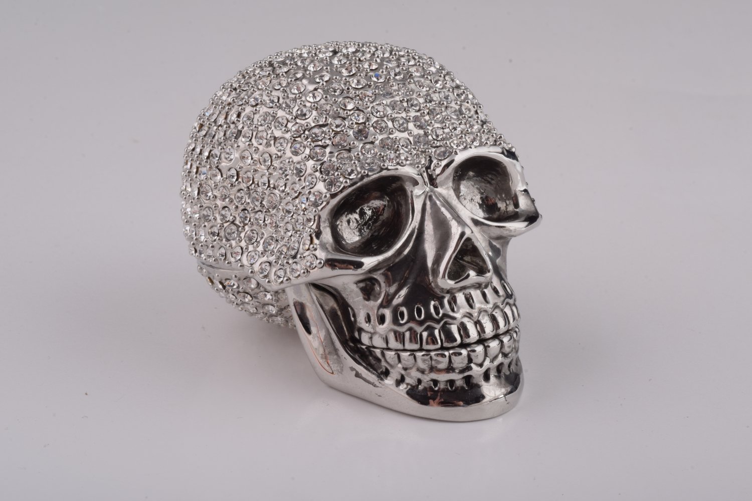 A beautifully crafted Silver Decorated Skull trinket box featuring intricate enamel painting and handpicked Austrian crystals, plated with 24K gold or 925 silver.