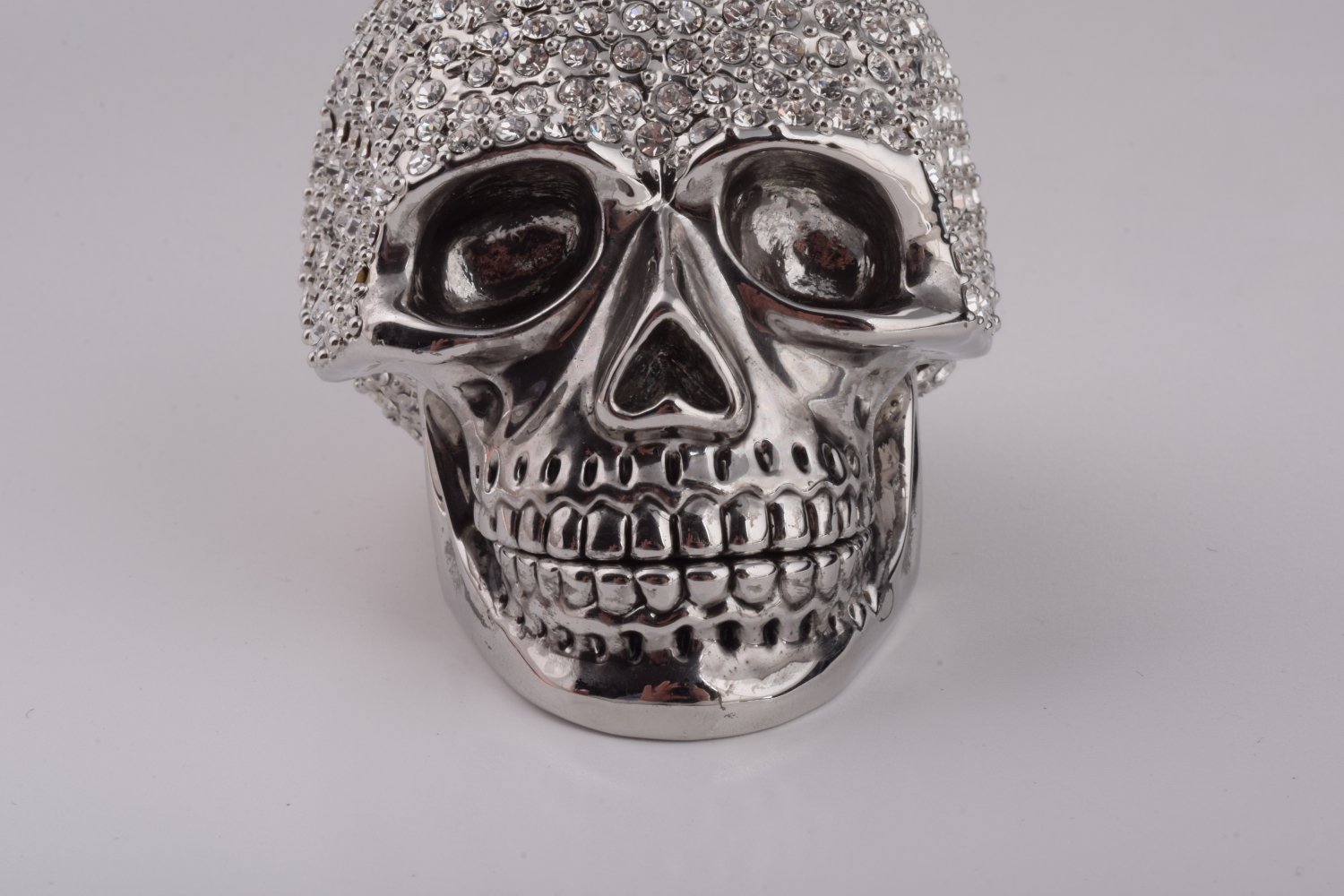 A beautifully crafted Silver Decorated Skull trinket box featuring intricate enamel painting and handpicked Austrian crystals, plated with 24K gold or 925 silver.