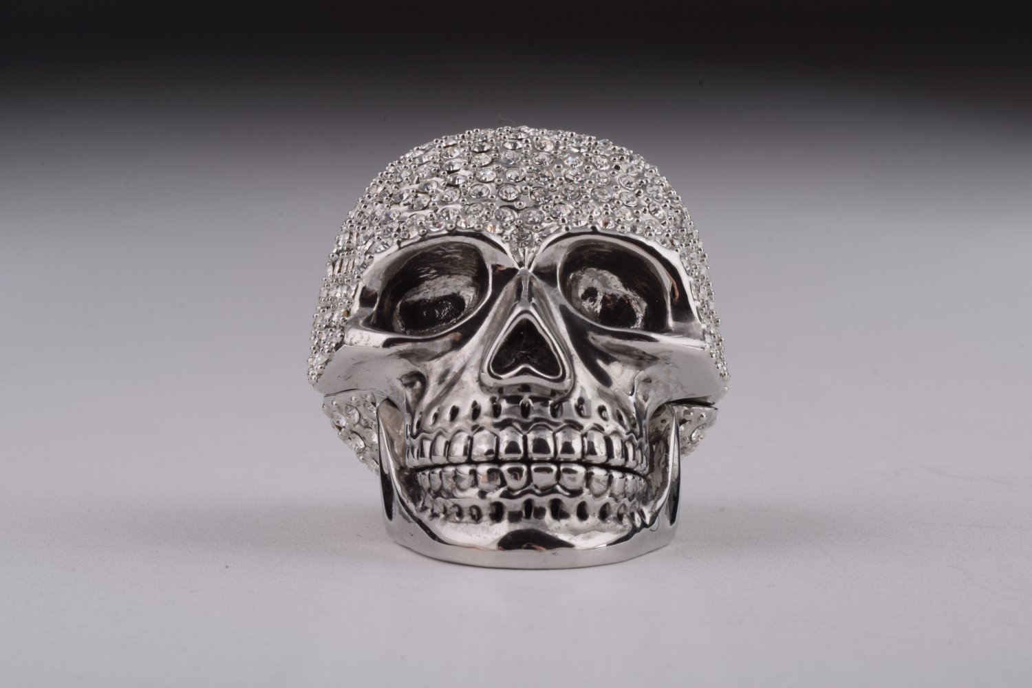 A beautifully crafted Silver Decorated Skull trinket box featuring intricate enamel painting and handpicked Austrian crystals, plated with 24K gold or 925 silver.