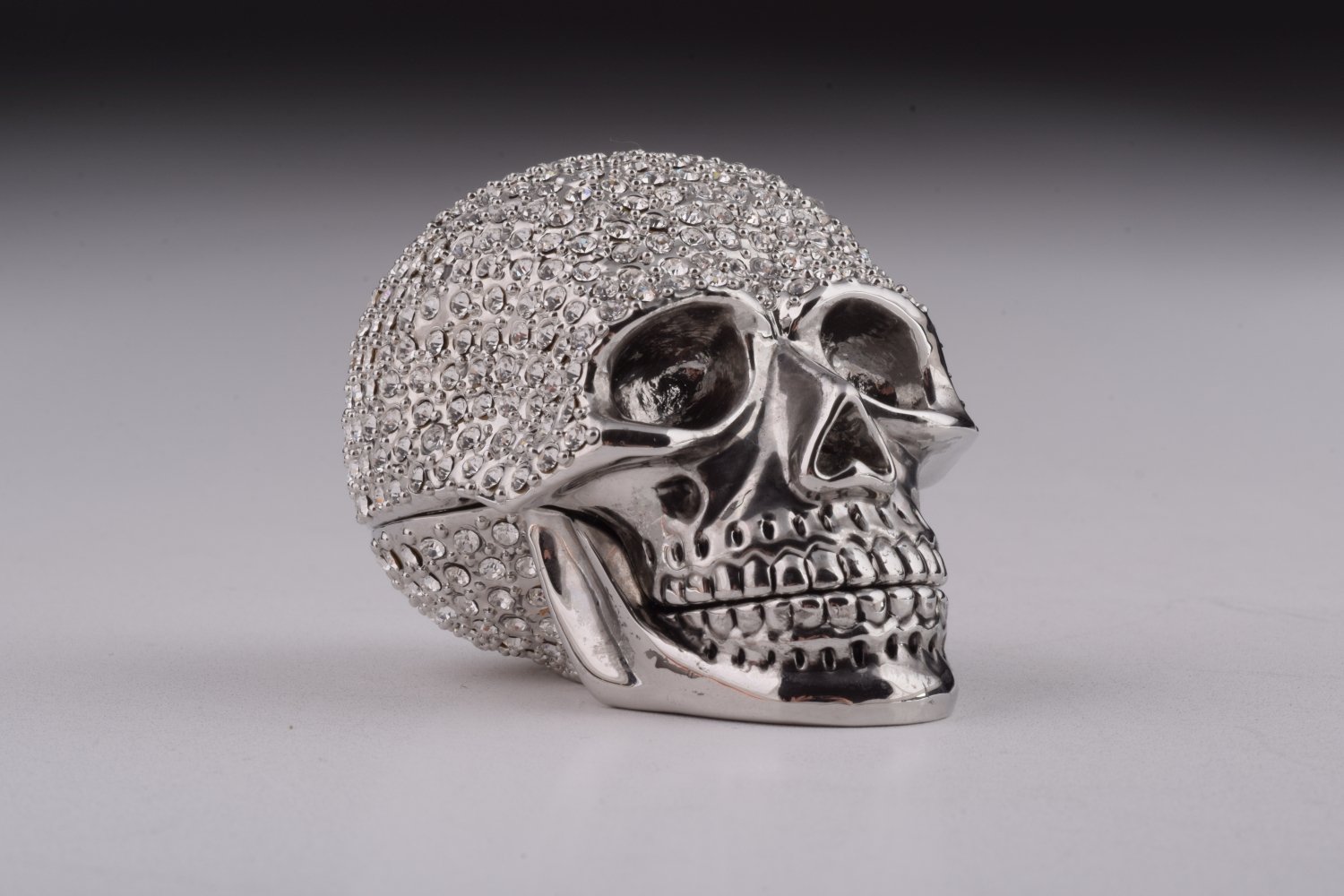 A beautifully crafted Silver Decorated Skull trinket box featuring intricate enamel painting and handpicked Austrian crystals, plated with 24K gold or 925 silver.