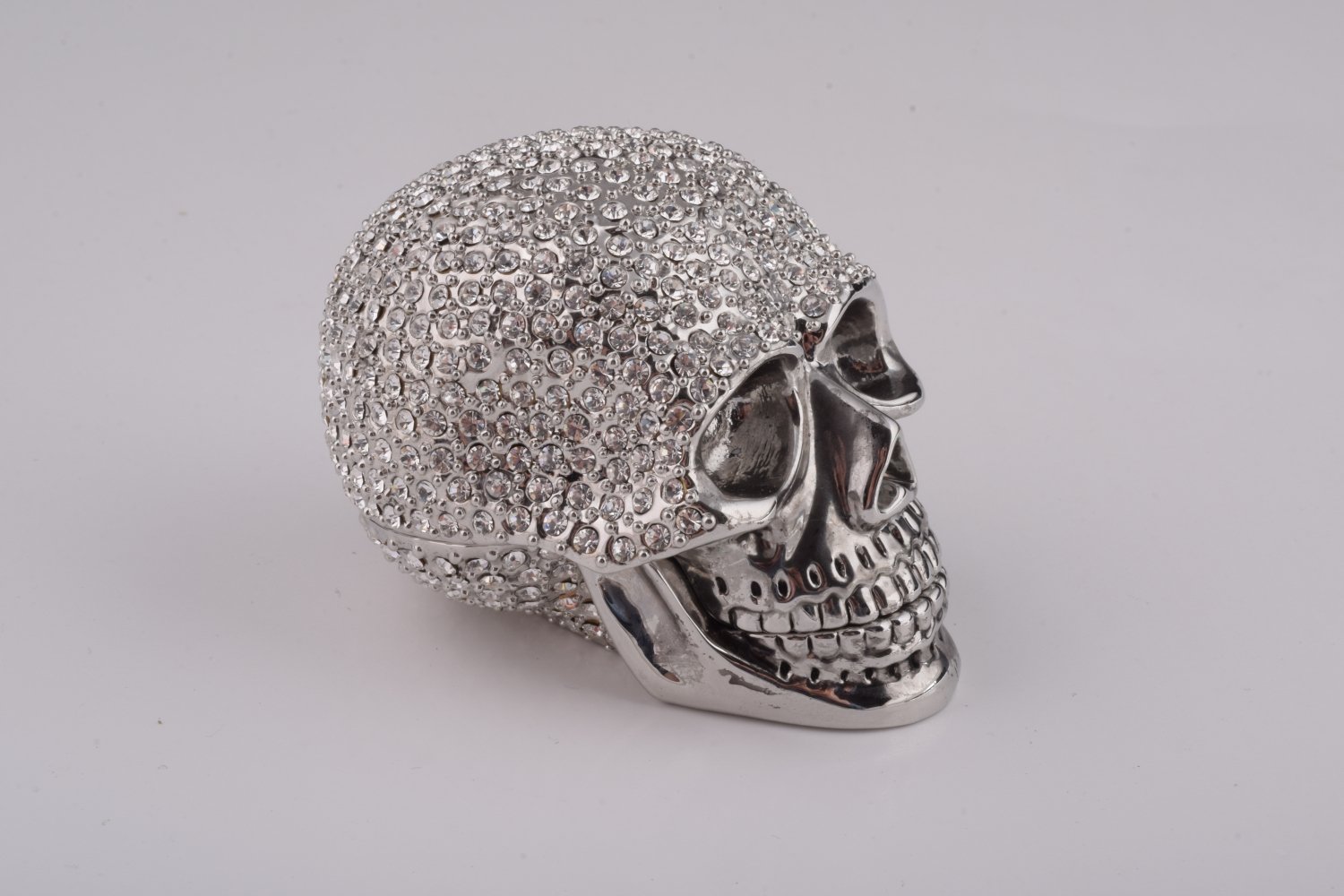 A beautifully crafted Silver Decorated Skull trinket box featuring intricate enamel painting and handpicked Austrian crystals, plated with 24K gold or 925 silver.