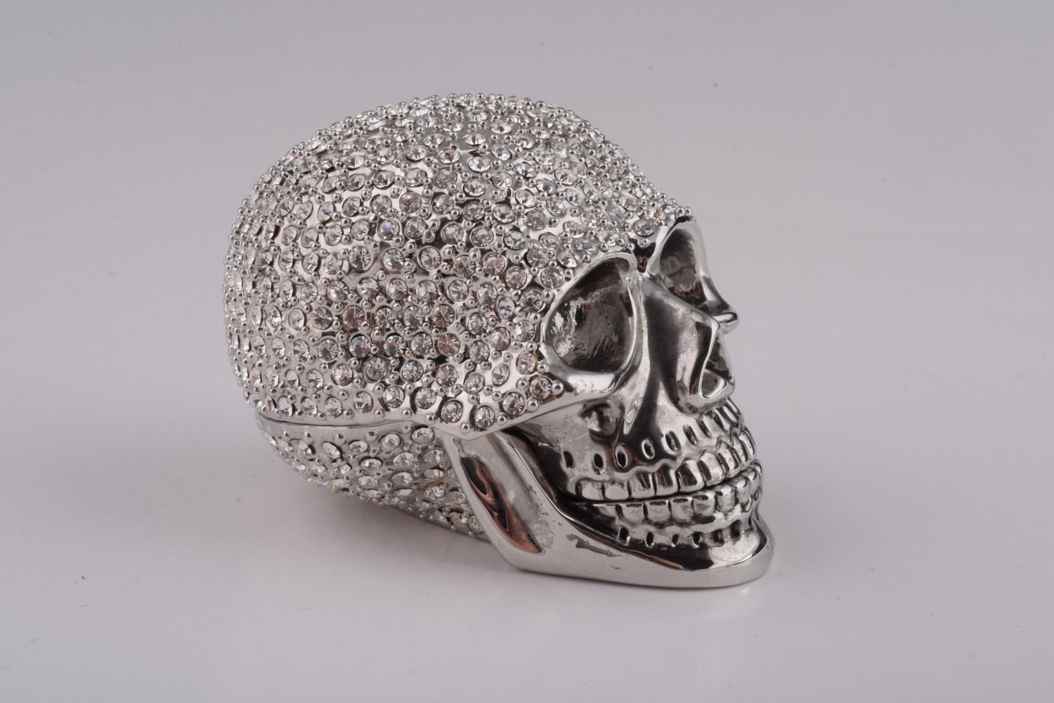 A beautifully crafted Silver Decorated Skull trinket box featuring intricate enamel painting and handpicked Austrian crystals, plated with 24K gold or 925 silver.