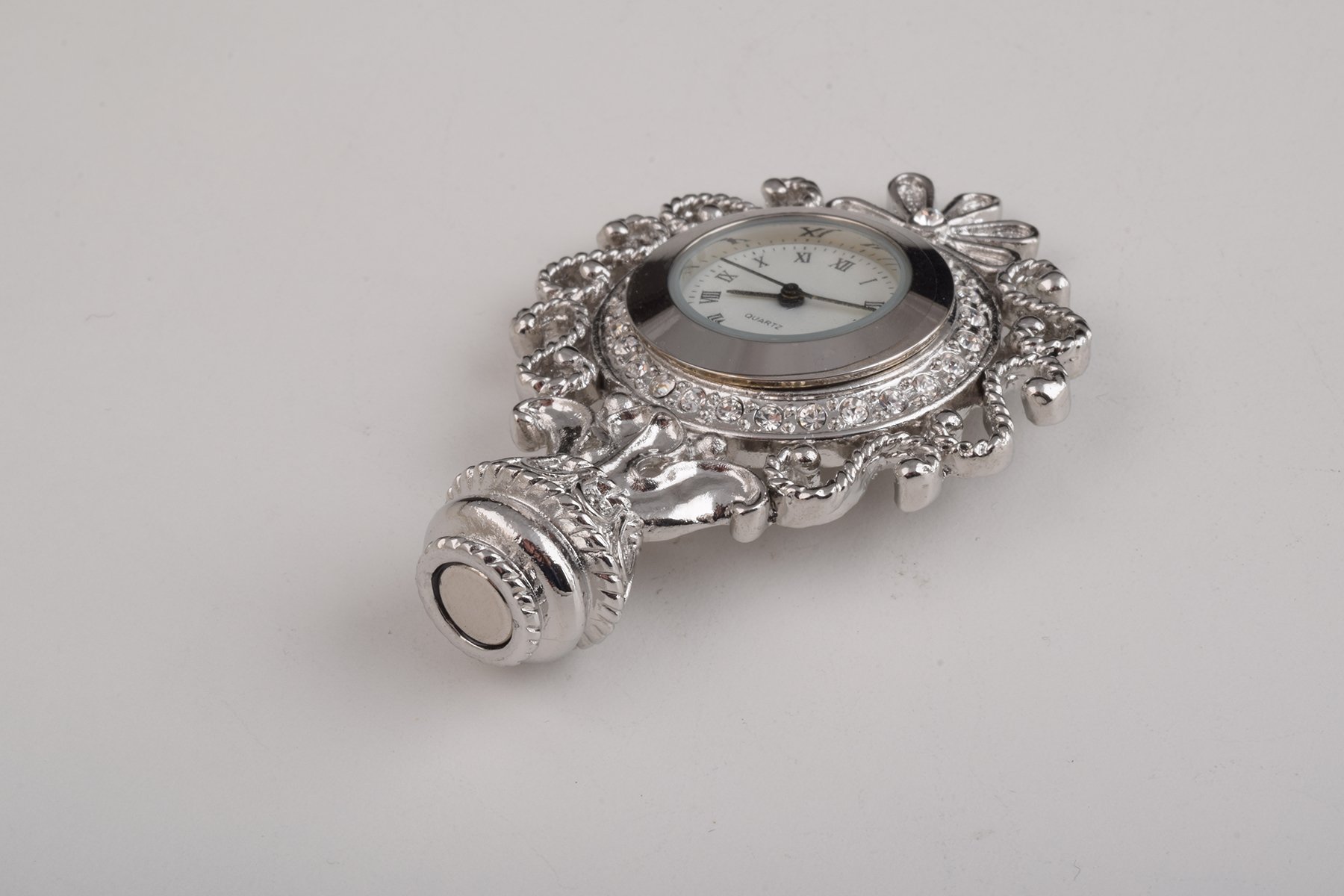 A beautifully crafted Silver Faberge Egg trinket box with a clock inside, adorned with Austrian crystals and plated in 24K Gold or 925 Silver.