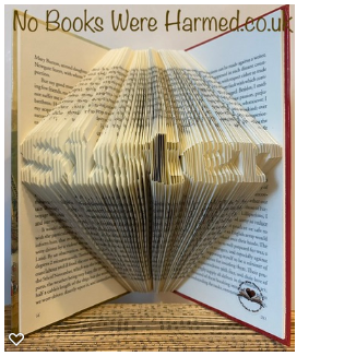 Hand-folded book art titled 'Sister', crafted from vintage books, showcasing intricate folds and unique colors.